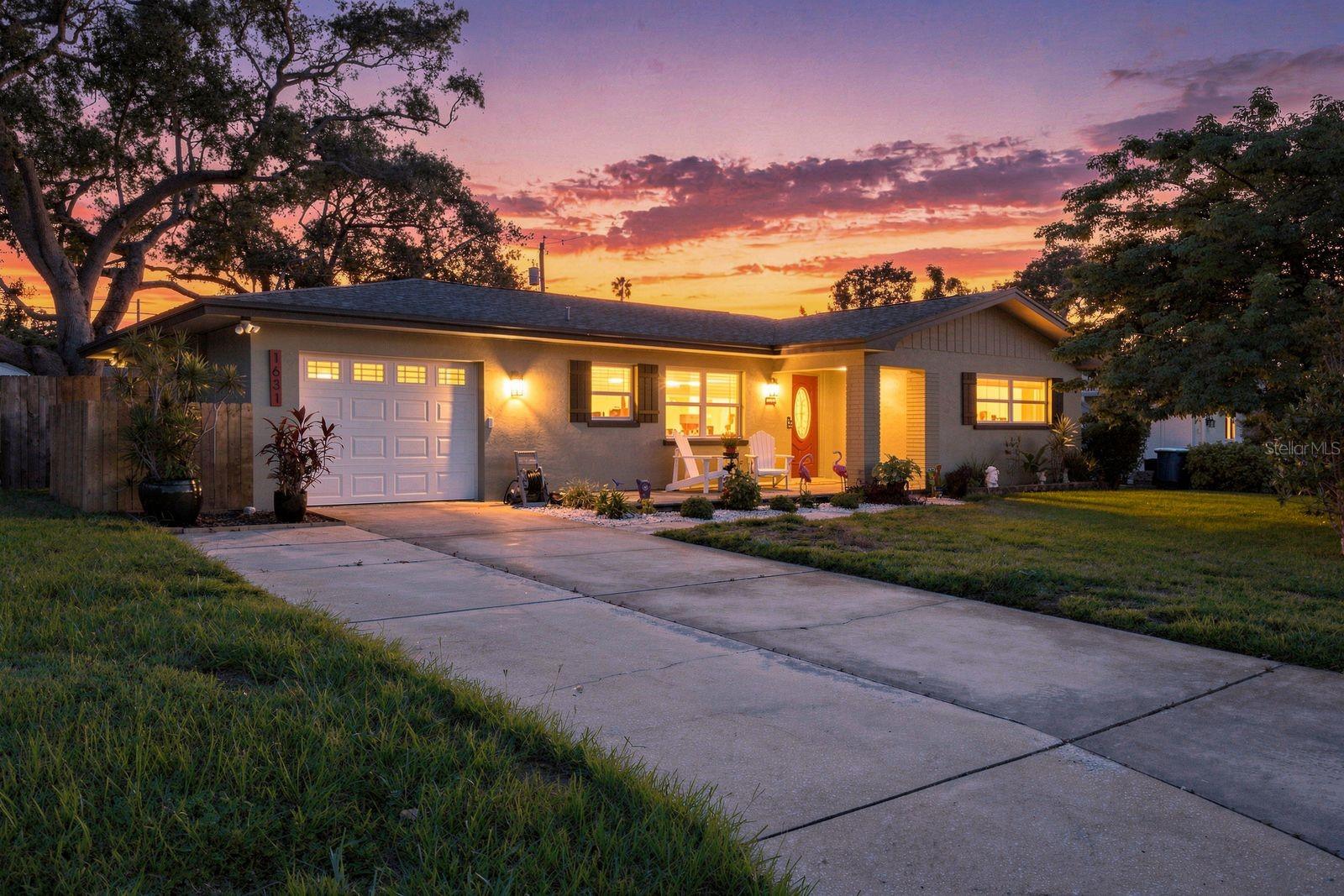 Mid-century soul, with Modern finishes and a Private backyard retreat. This 1959 Clearwater gem is a rare find. Set on a 0.18 acre lot with 1,420 heated square feet, and 2,029 total square ft. This 2 bedroom, 2 bathroom home pairs authentic character with a long list of major updates, all with NO HOA and in a FLOOD X ZONE. Original polished terrazzo floors run throughout, carrying a craftsmanship and shine you simply cannot replicate. The kitchen was fully renovated in 2022 with white shaker cabinetry, marble look counters with an arabesque tile backsplash, and a beverage/wine fridge, and all appliances were replaced in 2021. Both bathrooms are beautifully updated, one with a marble tiled tub and shower combo and quartz vanity, the other a sleek walk in shower with pebble stone floor. The dated popcorn ceilings have been removed and refinished with a smooth orange peel texture throughout. An open concept layout connects the kitchen, dining, and living areas, filled with natural light from oversized windows, plus a bright flex space perfect as a home office or sitting room. Step out to a screened sunroom with a hot tub, then into a private fenced backyard with a paver patio, mature oak tree, and tropical landscaping made for entertaining. Additional pavers accent the front of the home, and the irrigation system runs on a well to keep costs low. A one car garage adds everyday convenience, and the washer and dryer convey with the home. Just minutes from downtown Clearwater, the waterfront Coachman Park, home of The Sound, and the Pinellas Trail, with world famous Clearwater Beach only a short drive away. Retro roots, modern function, and true peace of mind. ROOF 2019, HVAC 2020, WATER HEATER 2020,DUCTWORK REPLACED & EXTENDED 2014/2015,GARAGE DOOR 2019,