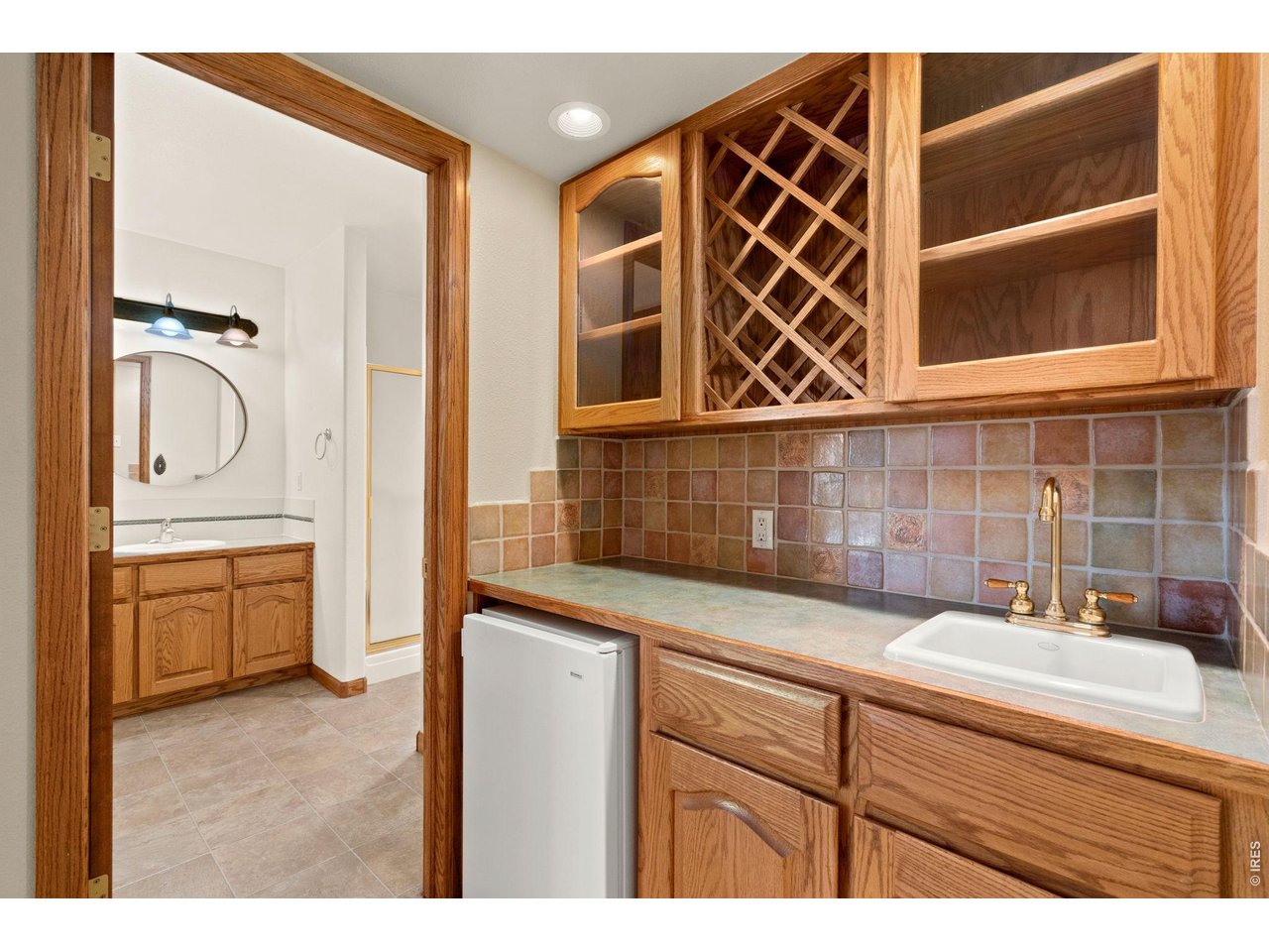 Experience quality craftsmanship, privacy, and convenience in this beautifully built Willard Holz home located in a centrally located gated community in Fort Collins-with no Metro District taxes. Set on a private half-acre cul-de-sac lot overlooking an HOA-maintained fountain, this spacious residence offers more than 4,200 finished square feet with 5 bedrooms, 3.5 bathrooms, and thoughtful spaces for everyday living, work, and entertaining. Inside, the home features a main-floor office or study, a welcoming family room with a gas fireplace, remodeled bathrooms, new carpet, newer LVP flooring, and a laundry room with a wash sink. The primary suite includes a 5-piece ensuite bathroom, luxury bath finishes, and a large walk-in closet. A finished basement expands the living space with a pool table area, wet bar, bathroom, bedroom, and flexible room ideal for music, study, or a second office. Additional highlights include a huge 1,010-square-foot garage, large, covered deck and patio, and a durable concrete tile roof with a Class A fire rating, low maintenance long life, exceptional weather resistance and efficiency. With its generous lot, desirable location, impressive square footage, and quality updates, this Fort Collins home offers comfort, function, and timeless appeal in a private gated setting. First American Eagle Premier Home Warranty Included.