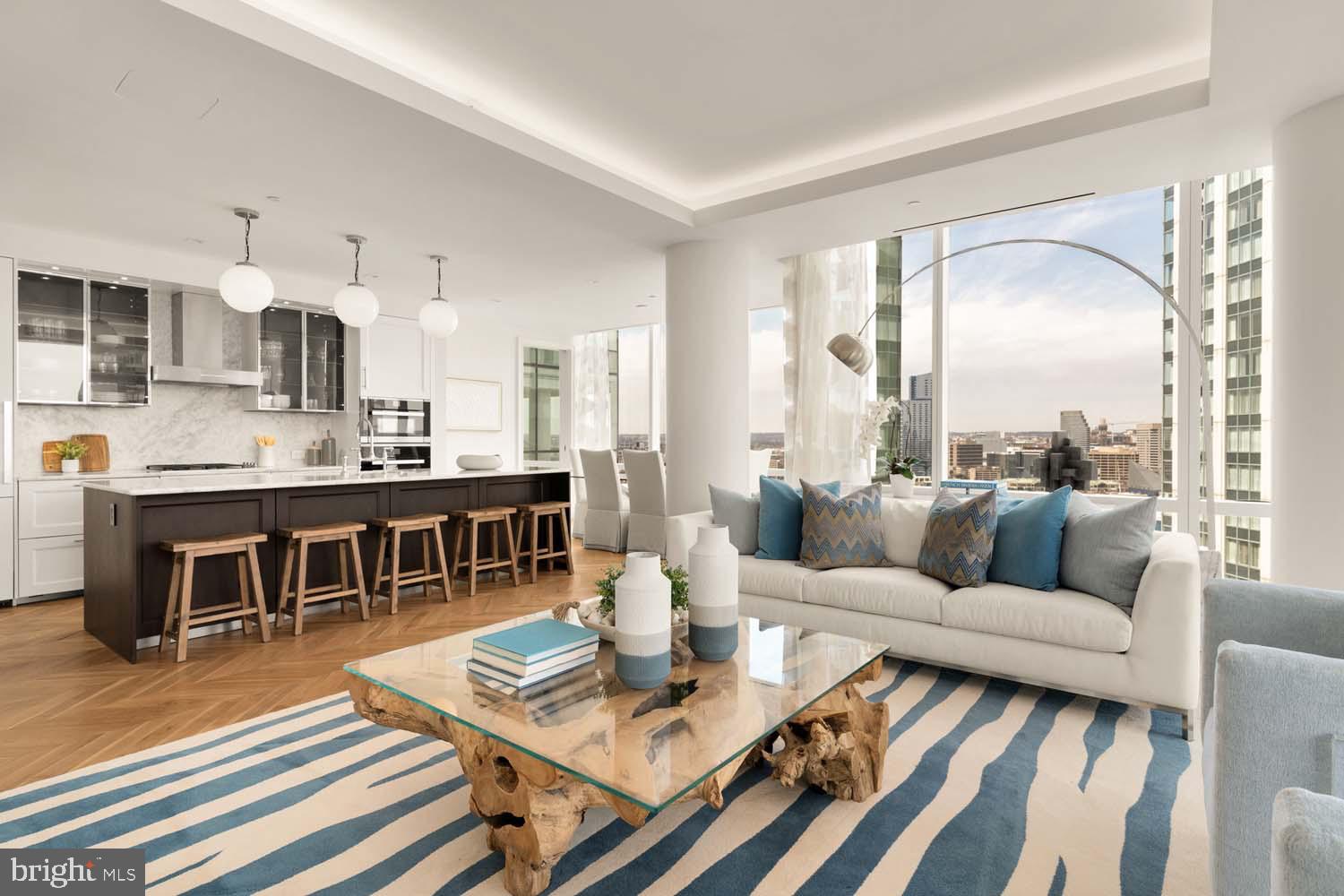 TWO-BEDROOM CORNER UNIT MODEL  WITH BALCONY AVAILABLE!Welcome to the Four Seasons Private Residences in Harbor East, where luxury meets lifestyle in Baltimore’s most coveted waterfront address. Perched above the city in a prime corner location, this exceptional two-bedroom, two-bathroom residence offers breathtaking views of the Inner Harbor and sweeping city skyline from nearly every room. With floor-to-ceiling windows that bathe the home with natural light, and a private balcony, the ever-changing waterfront scenery becomes part of your daily living experience. Thoughtfully designed to utilize every inch with purpose, this unit lives larger than 1,685 sq ft! Step into an atmosphere of sophistication with soaring ceilings, rich walnut chevron-patterned flooring, and designer finishes throughout. The gourmet kitchen is a chef’s dream, outfitted with Miele appliances, sleek Eggersmann soft-close cabinetry, luxurious marble stone countertops, and a built-in Sub-Zero wine fridge - perfectly blending timeless elegance with modern function. The primary suite is a tranquil sanctuary, offering two custom-built walk-in closets for optimal storage and a spa-inspired, marble-clad en-suite bath featuring a double vanity with designer finishes, a glass-enclosed walk-in shower with a built-in bench and niche, separate water closet, and a sculptural freestanding soaking tub that invites total relaxation. The second bedroom offers equal comfort and privacy with its own full bath and ample storage. Every inch of this home is elevated by exceptional attention to detail, all complimented by an absolutely breathtaking waterfront backdrop. The Four Seasons Private Residences Baltimore offers a turn-key elevated lifestyle. As a resident, you'll enjoy a private entrance where you will be met by our full service concierge and on-site building manager to assist with your every need, as well as exclusive access to the sprawling 28th-floor amenity level, where world-class services meet resort-style indulgence. Amenities include an indoor heated saltwater infinity-edge pool, a state-of-the-art fitness center, sauna, coffee station, billiard room, and numerous elegant gathering spaces. Multiple rooftop decks offer panoramic city and harbor views, complete with indoor and outdoor fireplaces, a grilling station, a dining area, and a kitchen, all ideal for entertaining. Completing this unparalleled lifestyle experience are a fully equipped conference room and a dedicated AstroTurf dog-walking area. This residence offers the rare opportunity to live within a full-service, hotel-branded building while enjoying the privacy and sophistication of a true luxury home. All set within steps of Harbor East’s acclaimed restaurants, shopping, and the waterfront promenade. This is a MUST SEE TWO BEDROOM!! Immediate occupancy is available. Come see what all the fuss is about!