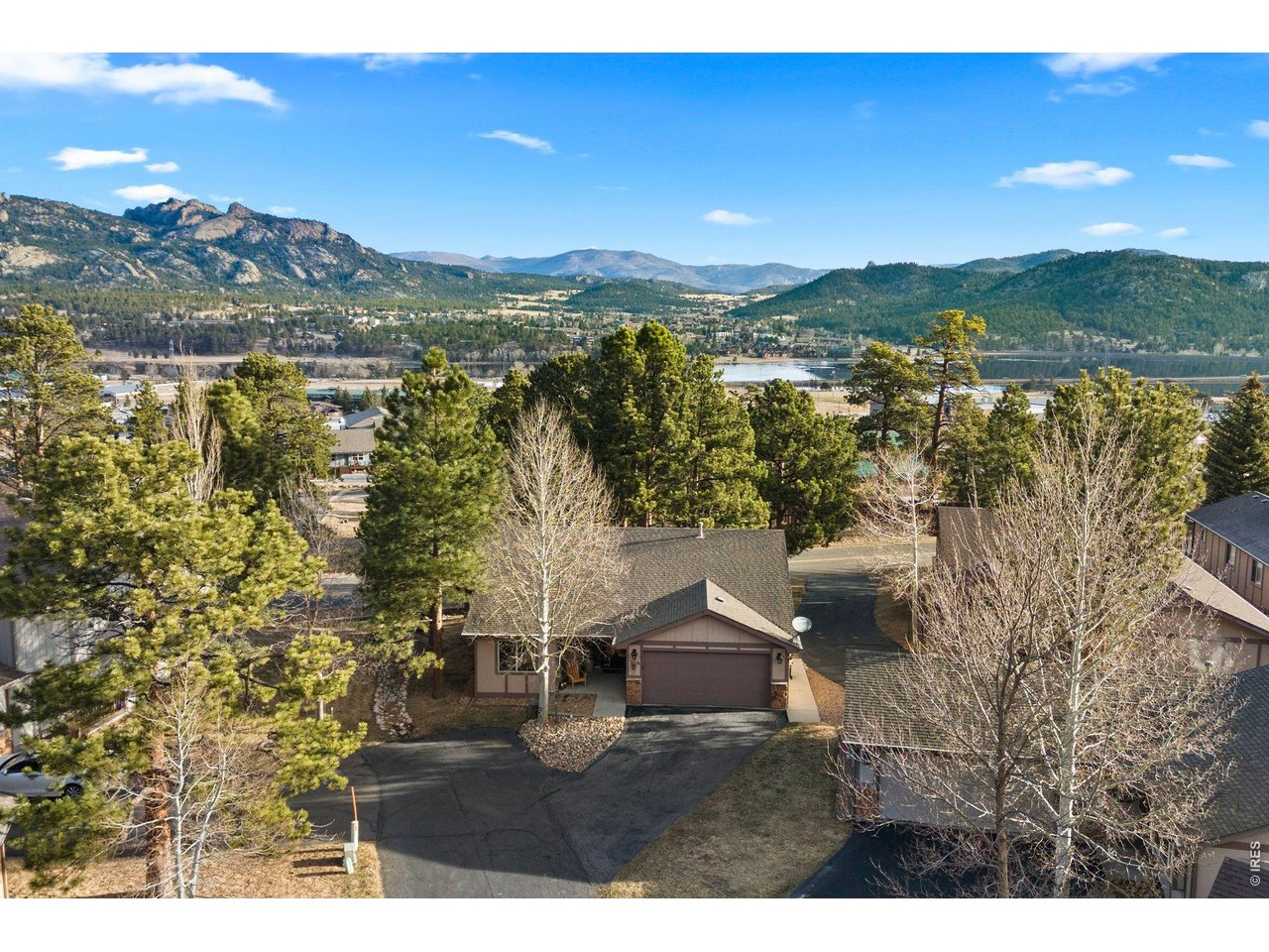 Tucked at the end of a quiet cul-de-sac in the desirable Mountain Golf Villas subdivision, this beautifully remodeled, stand-alone 2-bedroom, 2-bathroom home offers the perfect balance of luxury, comfort, and natural beauty. Whether you're seeking a full-time residence or a serene mountain retreat, this home embodies the Colorado lifestyle at its finest. Step inside and feel immediately at ease. The open-concept, single-level floor plan creates an effortless flow throughout, with upgraded features at every turn. The expansive living room invites you to relax by the cozy gas fireplace or step through sliding doors to your private walkout deck-perfect for morning coffee, afternoon reading, or evening stargazing. The kitchen is a chef's delight, featuring stunning leathered granite countertops, a new sink with modern fixtures, stainless steel appliances, and a classic subway tile backsplash. Beautiful laminate flooring, new lighting, and ceiling fans add a fresh, contemporary feel throughout. Both bathrooms have been tastefully updated with tile floors, new showers, and granite vanities, copper sink, offering a spa-like experience at home. Outdoors, enjoy multiple spaces designed for relaxation-a charming front porch sitting area, a gated private deck, and a peaceful backyard that feels like your own secret garden. The oversized two-car garage adds convenience and ample storage. Meticulously maintained, this home includes thoughtful upgrades such as a new hot water heater and screened gutter guards. And then-there are the views. From nearly every window, take in the breathtaking beauty of the surrounding mountains and abundant wildlife. Located moments from a scenic 18-hole golf course, hiking trails, world-class restaurants, and the iconic Stanley Hotel, you'll find everything you need just beyond your doorstep. This is more than a home-this is a lifestyle. A place where seasons change in vibrant color and where every detail has been crafted for your comfort and joy.