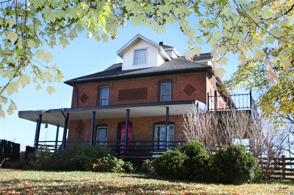 Timeless Brick Colonial on Expansive Acreage! Step back in time with this stately 1900-built brick colonial offering charm, space, and opportunity. Nestled on 4 beautiful acres, this property combines historic character with endless potential. Featuring two barns, two garages, and a shed, the possibilities are abundant—whether for hobby farming, storage, or even transforming one barn into an event venue (with township approval). The home itself is ready for your personal touches and creative vision. Situated on a main road with high visibility, this property may also offer commercial zoning potential (with township approval)—ideal for a business, venue, or investment opportunity. While the home needs some updates, the location, acreage, and flexibility make it a rare find! Newer furnace, windows, pressure tank. Updated electrical in barns and garage. New Barn Roof, floors and lean-to. Bring your ideas and make this one-of-a-kind property shine again.