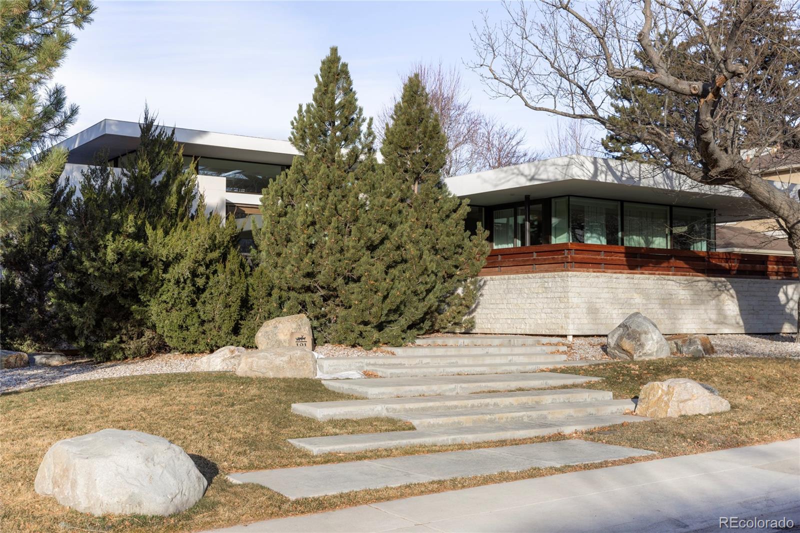 Step into this jaw-dropping modern ranch style home that redefines effortless luxury. Upon opening the 10' glass pivot door, you experience pure sophistication and luxury finishes throughout. The open floor plan creates a seamless flow between living room, dining room, and kitchen all surrounded by a wall of windows that flows into the backyard creating fabulous indoor/outdoor living. The interior is blasted with natural light, clean architectural lines and a thoughtfully restrained palette allowing the beauty of organic materials—warm wood, natural stone, and subtle textures—to take center stage. Spoil yourself in the elegant main floor primary suite with the spa inspired bathroom. You will also find the other 2-bedroom suites on the main floor. Head to the lower level that transforms leisure into an art form, with custom bookshelves, a refined lounge area, custom stunning bar, wine room, fitness studio and 2 secluded guest suites that offers ultimate in comfort.  This home is so special - you just have to see all that it has to offer!!  The uncomplicated design: refined, organic, and effortlessly gorgeous—a home created for those who appreciate beauty that feels as good as it looks.