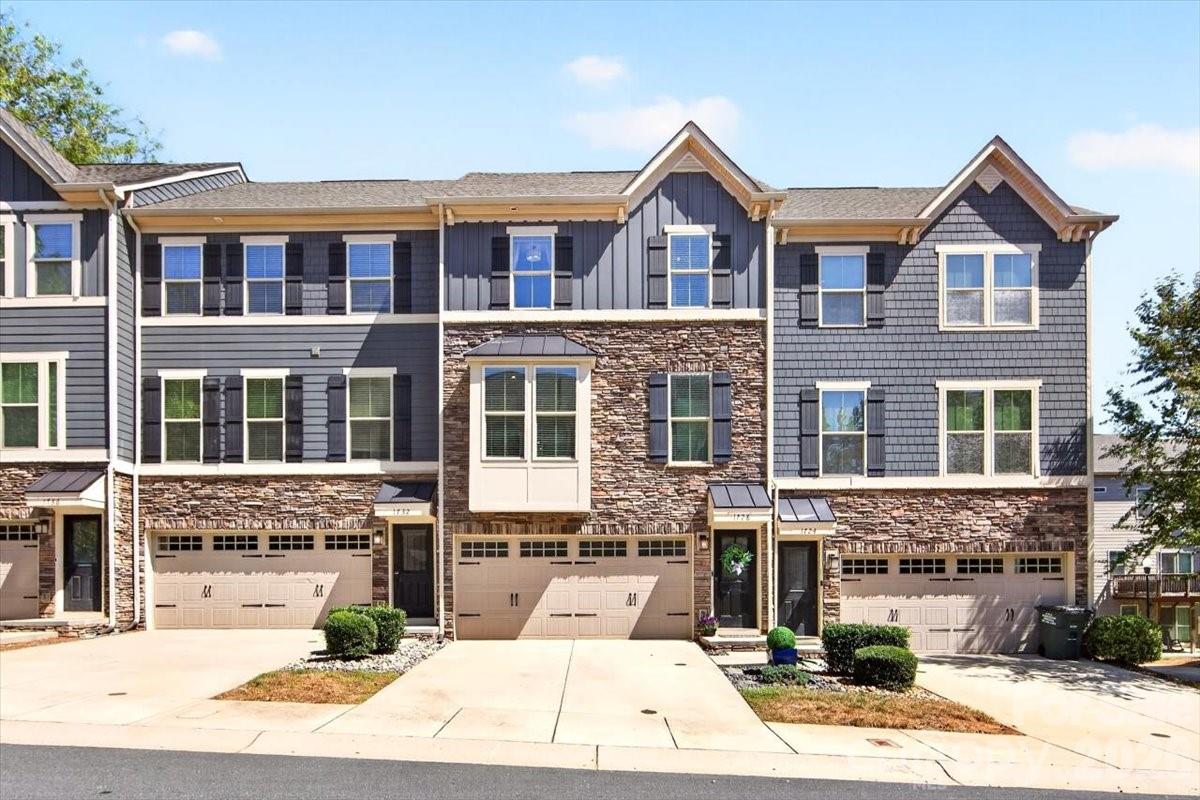 Welcome to this exceptional townhome in the charming community of Townes at Oakhurst, offering low-maintenance living with 3 bedrooms and 2.5 bathrooms.  Spanning three stories and approximately 2,000 square feet, this thoughtfully designed townhome offers a modern, spacious, and functional layout. Lovingly maintained by its original owner.The main floor showcases an open-concept layout with a bay window in the spacious living room. Hardwood flooring extends throughout the main level and staircase. The bright and airy space includes the kitchen, dining area, powder room, and doors leading to the deck, creating the perfect spot for grilling, outdoor entertaining, and relaxation.The gourmet kitchen features stainless steel appliances with gas range, elegant white linen cabinetry, white quartz countertops, a spacious center island with seating, updated matte-black commercial-style pull-down faucet and coordinating cabinet pulls, tiled backsplash, and pantry.  Upon entering the lower level, you’ll find a versatile flex space with hardwood flooring, ideal for a home office, gym, media room, or additional entertaining area. This level also features custom cabinetry with a convenient drop zone, access to the outdoor living space with a stamped concrete patio, and an attached 2-car garage.The upper level hosts the owner’s suite with tray ceiling, crown molding, a spacious walk-in closet, and a luxurious en-suite bath complete with a double vanity, walk-in shower with ceramic tile surround, and linen closet. Two additional bedrooms share a full hall bathroom including a secondary bedroom accented with crisp white board-and-batten wainscoting. A conveniently located laundry room completes the upper floor.Enjoy easy access to Uptown Charlotte along with a variety of nearby restaurants, breweries, and local favorites that create a vibrant, connected lifestyle. Ideally located in the sought-after Oakhurst neighborhood, this home is just minutes from Cotswold, SouthPark, Elizabeth, NoDa, and Plaza Midwood, while tucked within a quiet community setting. Walk to neighborhood favorites like Night Swim Coffee, The Teal Turnip, Jersey Mike’s, Anytime Fitness, a local pizza shop, nail salon, and more. Common Market is less than half a mile away.