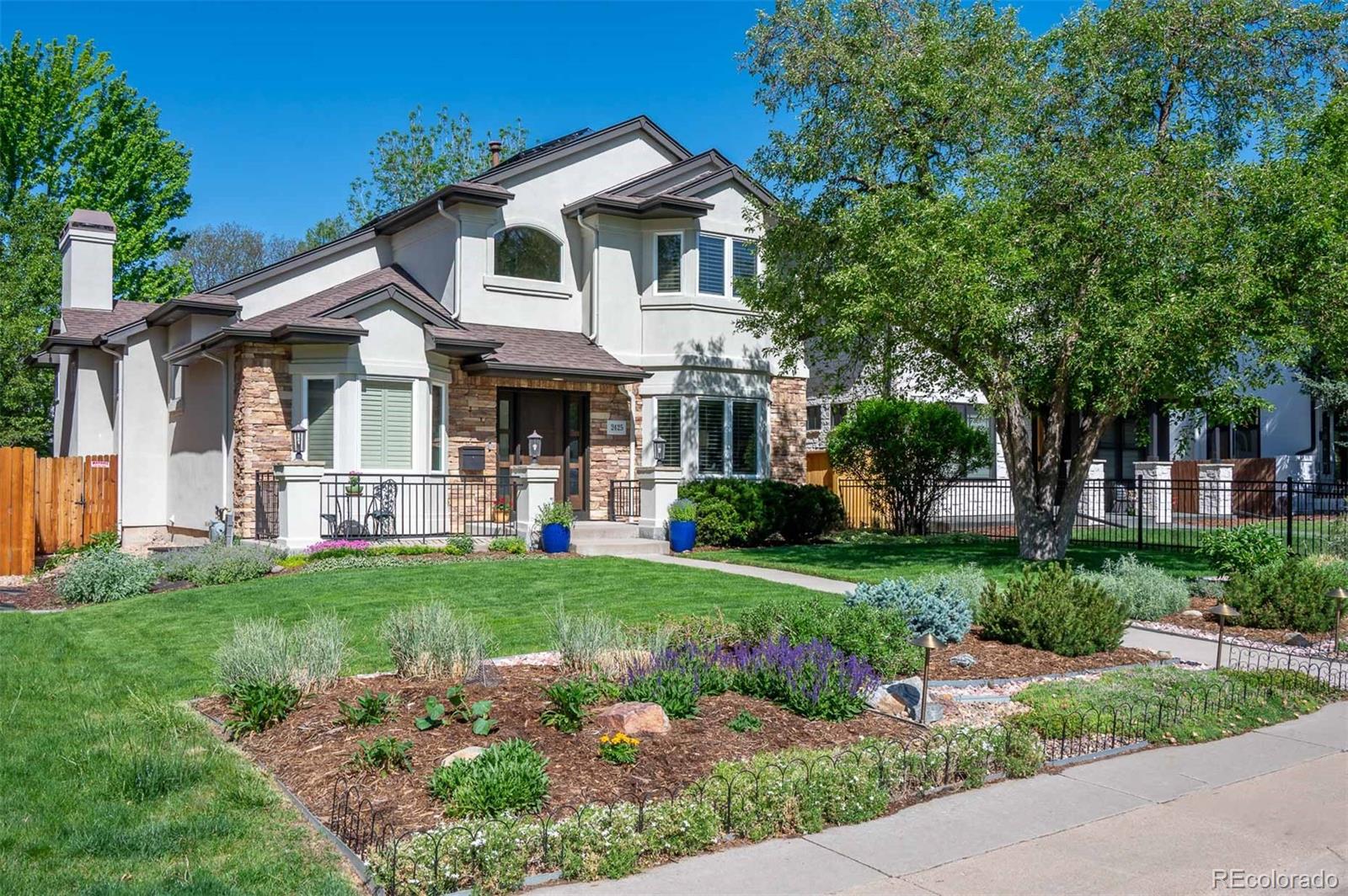 Classic. Updated. Meticulous. This beautiful home, located on a prime Observatory Park block, is move-in ready and waiting for its next lucky owners. Tastefully and thoughtfully updated throughout and magnificently maintained, you'll be impressed! Start with the lovely remodeled and updated Kitchen featuring a large center island, granite countertops, maple cabinets, and high-end stainless appliances. A sunny Breakfast space overlooks a newer back deck and shady patio, then connects to a comfortable Great Room with built-ins, gas fireplace, and beautiful windows overlooking the well-cared for backyard. Notice the custom updated iron railings on the stairway. On the main floor the spacious formal Dining and Living Rooms are perfect for entertaining. The sunny main floor office could also be a main floor bedroom. Beautiful hardwood flooring throughout the main floor and new upstairs. All the bathrooms have been updated, including a total gut and remodel of the five-piece Primary En-suite Bath. Three bedrooms up, including a peaceful Primary Suite. A large, bright Family/Entertainment Room in the basement is just made for movies and gametime. The basement bedroom is also spacious and bright with an En-suite 3/4 Bath. Beautiful gardens and patios outside beckon you to enjoy the summer weather! So many upgrades in this special home! See the full list included in supplements.  Many energy efficiency upgrades throughout as well, including owned solar panels, upgraded insulation, and a heat pump water heater. Observatory Park with its gorgeous old growth trees, is one of Denver’s most beloved neighborhoods. Multiple parks, playgrounds, and places to stroll, with easy proximity to shopping, many  restaurants and I-25 make this a favored location. You literally have nothing to do but move right in and make it your own!