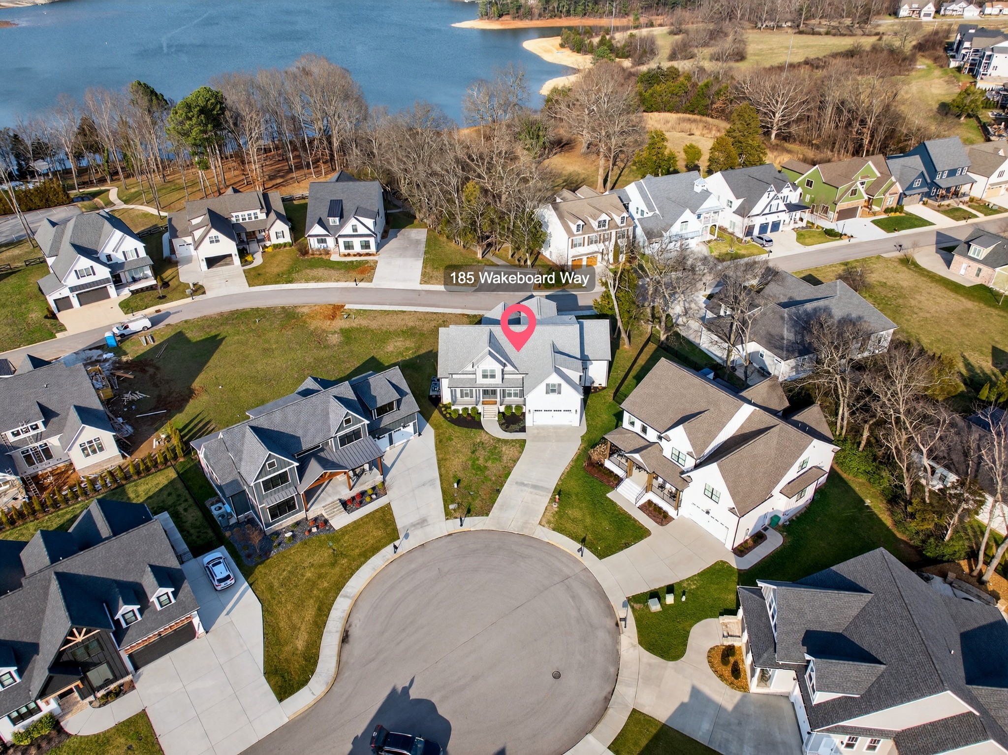 Lake life meets living space in this standout Twin Creeks home inside a Tims Ford Lake gated, marina community. Uniquely positioned, the front entry opens to a quiet cul-de-sac while the rear of the home sits just across from a marina walking path, creating an ideal blend of privacy and walkability. From the back covered porch and upstairs covered balcony, you’ll enjoy partial lake views.With over 3,800 square feet, this is one of the larger homes in the neighborhood and fits entertainers, large families, or buyers who want room for everyone to gather. The layout offers six bedrooms, four and a half baths, a bonus room, a covered front porch, and an impressive 40x13 covered rear porch with outdoor fireplace made for game days, long evenings, and memorable weekends. There is also a patio with a natural gas stub ready for your grill.Inside, the main level features wood flooring throughout the living areas, trim detail, and wainscoting. The vaulted Great Room is anchored by a gas fireplace with built-in bookcases on both sides, while double sliding glass doors open to the covered porch. The kitchen features granite surfaces, a large island, stainless appliances, double ovens, gas range, and a walk-in pantry. Also on the main level are a formal dining room, a drop zone with cubbies, and two bedroom suites—including the primary and a secondary bedroom—each with a bath and walk-in closet.Upstairs, four additional bedrooms and a large bonus room provide flexibility, and one bedroom opens directly to the covered balcony with a sight line toward the water. The epoxy-finished garage adds another polished detail.Beyond the home itself, Twin Creeks offers neighborhood pools, a clubhouse, and easy access to Twin Creeks Marina and Drafts & Watercrafts. Boat rentals, paddlesports, lakeside dining, downtown Winchester, Tims Ford Lake, Tims Ford State Park, and Bear Trace golf help make this a place where weekends feel bigger, summers feel longer, and memories come easy.