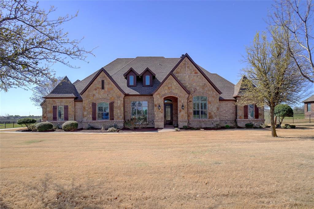 Private well, NO Water Bill, and NO City Taxes!  Northwest ISD ... Excellent friendly community in Fort Worth.  Move-in Ready!!  Come visit this clean, custom home on a prime 1-acre lot with large trees and private views located in Vista Ranch. Open floor plan with 4 bedrooms, 3.5 baths. Oak hardwood floors in foyer, study, main suite bedroom & walk-in closet, dining room, hallways, bedrooms 2 & 3. All windows include 2.5-inch white wood shutters. The dining room includes a boxed ceiling, painted case window frame & hand trowel texture. Study with built-in desk & shelves. Large open living area with stone fireplace, breakfast nook with pleasant backyard view. Kitchen opens to living area with brand-new stainless-steel appliances, custom cabinets, granite countertops, large pantry for extra storage with tile floors. Downstairs the Primary bedroom has a large his & her walk-in closet with 2 built-in dressers & a full length mirrors. The Primary bathroom has dual vanities, Jacuzzi Jetted tub and a large tiled walk-in shower. Upstairs, the large game room includes a game table area with a great view of the backyard. Upstairs the large media room is wired for surround sound and lighting fixtures. Upstairs private guest bedroom with a window seat to enjoy the view and access to a full bath. Large utility room with space for washer, dryer, refrigerator with water connections, stainless steel sink wash basin and hide-a-way ironing board. Large L-Shape walk-in storage space under stairwell. 3-car garage with convenient access to the backyard.