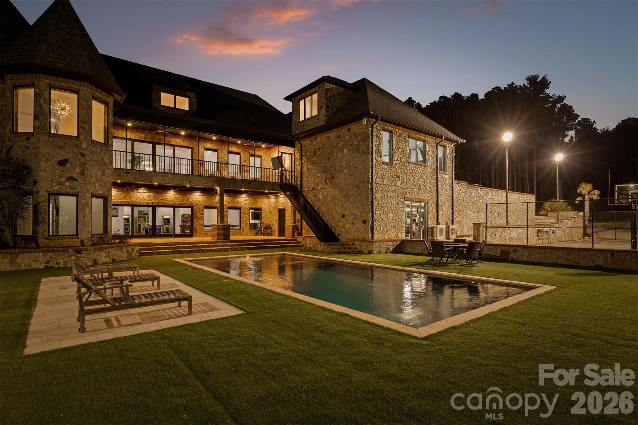 Welcome to the Crown Jewel of Lake Norman Living.Tucked away in the prestigious Twinn Coves on Morrison community, this magnificent gated Modern Tuscan Estate sits on nearly 9 private acres just minutes from the sparkling shores of Lake Norman State Park. Custom-built with obsessive attention to detail, this 11,241 square foot masterpiece blends Old World elegance with modern luxury — and elevates the very definition of resort-style living.From the moment you arrive through the private gated entrance, it's clear this is no ordinary estate. Soaring ceilings, select marble tiling, and curated finishes set the tone throughout, while expansive entertaining spaces on every level ensure there's always room for the grandest of gatherings. The chef's kitchen is as functional as it is stunning, and the custom-designed wine cellar — crafted in a rich, old-world style — is a connoisseur's dream.Entertainment here isn't an afterthought — it's a lifestyle. Host cinematic nights in your private in-home movie theatre, challenge guests in the vintage arcade game room, get a fresh cut in your very own in-home barbershop, or wind down in the sophisticated wine room. For fitness enthusiasts, a fully equipped indoor gym keeps you at your best without ever leaving home.Step outside and enter your personal resort. A sparkling pool and expansive pool house with outdoor cooking area anchor the grounds, while a half football field, outdoor basketball court, custom mini golf course, and a playground set ensure fun for every age and every occasion. The lush, meticulously maintained acreage also features walking trails and room to roam — a rare combination of space and serenity.Security and peace of mind come standard, with a comprehensive whole-home security system featuring full-range camera coverage and a gated private entry keeping the estate fully protected.All of this, just moments from the waterfront dining, boating, and vibrant recreation of Lake Norman — and with easy access to I-77 for a seamless commute to Charlotte.This is more than a home. It's a destination. Schedule your private showing today.