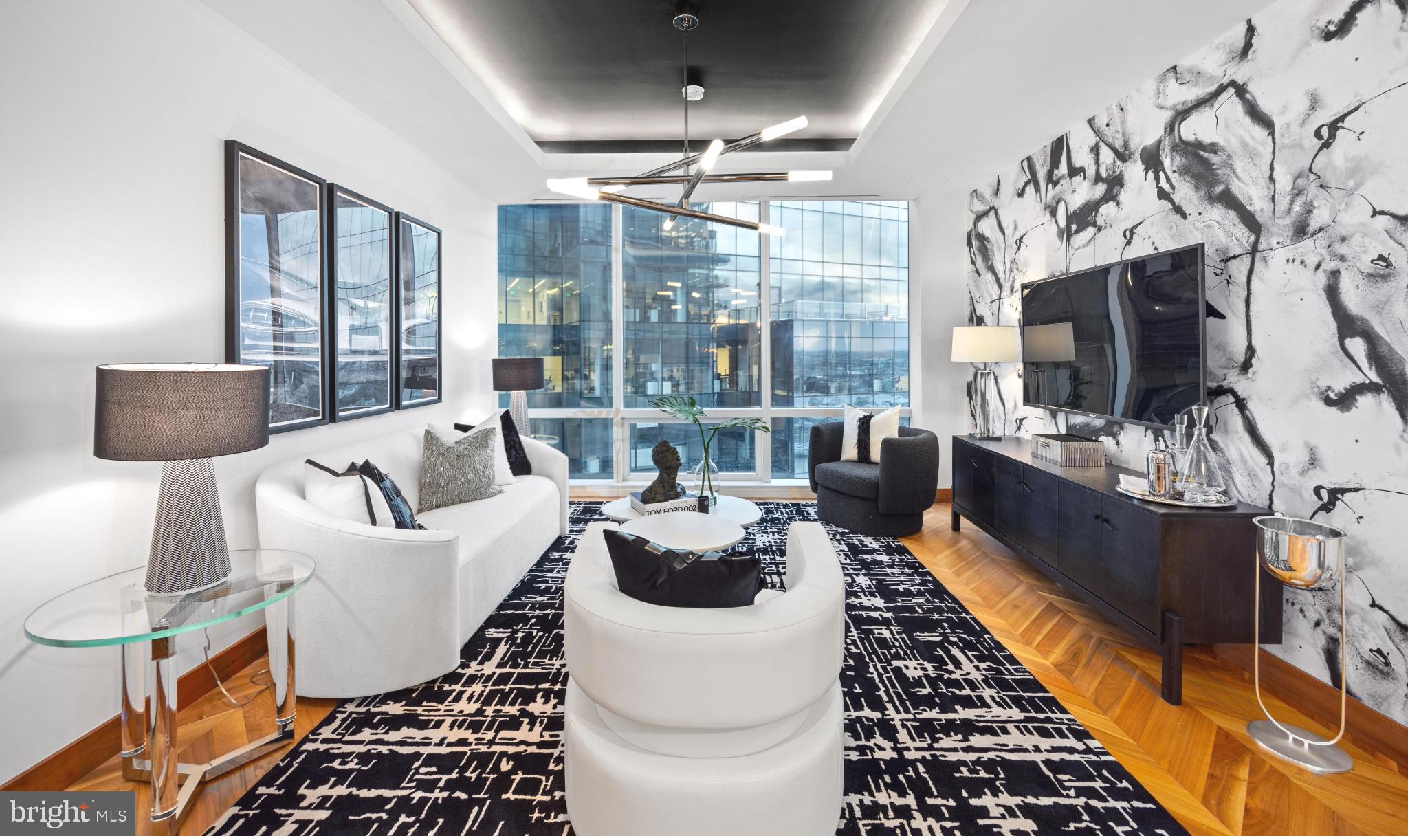 Discover luxury city living in this gorgeous 19th-floor home in the prestigious Four Seasons Private Residences.  Located in Baltimore’s vibrant Harbor East neighborhood, this elegantly designed home features one-bedroom, one-and-a-half-baths, and a den, ideal for an office, work-out space or additional bedroom.  A  spacious open layout seamlessly connects the kitchen, dining, and living areas - perfect for both relaxation and entertaining.  Soaring 10-foot ceilings and floor-to-ceiling windows flood the space with natural light, highlighting beautiful details such as walnut herringbone wood floors, designer lighting, and a chef-caliber gourmet kitchen outfitted with Miele appliances.  The primary suite features a generous walk-in closet and a luxurious marble en suite bath complete with a dual vanity, and soaking tub. Every element is crafted to the highest standard, offering comfort and elegance in equal measure.  Residents enjoy access to the legendary Four Seasons service and amenities, including a private indoor pool and spa, fitness center, restaurants, and meeting rooms,  ensuring a luxury living  experience in one of Baltimore’s most sought-after addresses.  And of course, enjoy the city’s best waterfront dining, boutique shopping, cultural attractions, and recreational activities—right at your doorstep in Harbor East.