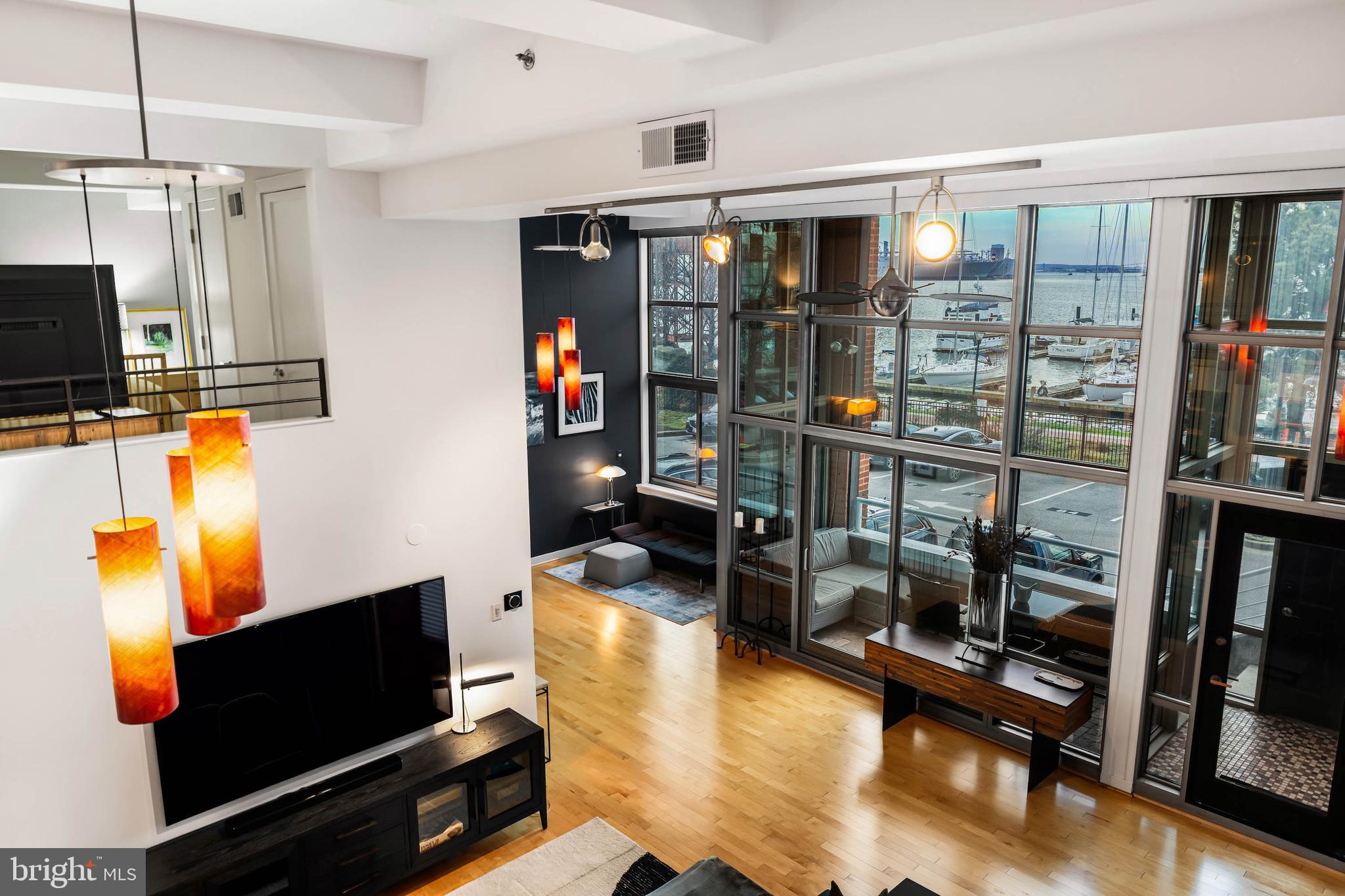 ESSENCELive authentically. A sublime condominium at the iconic Canton Cove, this stunning three-story architectural gem — two units masterfully combined — offers sweeping, unobstructed views of the Inner Harbor. Floor-to-ceiling glass floods every level with natural light, while the open loft layout creates an effortless sense of space and flow. The harbor is your constant backdrop: shimmering water, passing boats, and an ever-shifting skyline that transforms with the seasons. Completely refurbished this year, no detail was overlooked. Rich new hardwood floors run throughout, fresh paint, curated wallcoverings, and fully updated bathrooms elevate every corner. New heating, air conditioning, and a split system unit ensure year-round comfort.Step outside to the waterfront promenade — ideal for morning runs, leisurely walks, or coffee with friends. World-class dining, entertainment, and cultural venues are all within steps. Two dedicated parking spaces — one private garage with direct unit access, one open-air space directly outside — add rare convenience to city living. A 24/7 secured building provides complete peace of mind. Here, the harbor greets you at dawn and glitters you to sleep at night, wrapping daily life in a beauty that is effortless, timeless, and entirely your own. Cultivate your existence. The art of uniting human and home.LOCAL FLAVOR AND PROVISIONSCanton offers a vibrant waterfront experience and historic charm centered around O’Donnell Square’s restaurants and pubs. Treat yourself to pastries at Cafe Dear Leon or stop at the waterfront restaurants along Boston Street or in the Can Company. Stock up on provisions at DiPasquale’s and Harris Teeter.OUTINGS AND LEISURESEnjoy the vibrant energy of the waterfront promenade, take a water taxi ride to explore the harbor or relax in Patterson Park. Canton Waterfront Park is a hot spot for free outdoor summer concert series, and annual food and drink festivals. Peruse the shops around O’Donnell Square or enjoy the arts and theater district in Highlandtown.PROXIMITYClose to Fells Point, Harbor East, Little Italy, Brewer’s Hill, and about 10-15 minutes to downtown. Easy access to I-95. Approximately 28 minutes to BWI and 17 minutes to Penn Station.REGIONCanton, MD, was named by Irish merchant John O’Donnell in 1785 after the Chinese port city of Guangzhou (formerly called Canton) to honor the city from which he transported tea, silk, and spices. Historically, the neighborhood was built by industrial workers and is known for its classic Canton Square of rowhomes, painted screens, and the Canton Waterfront Park. The nearby Brewers Hill area is famous for the huge, illuminated Mr. Boh sign, which originated from the Gunther and National breweries.