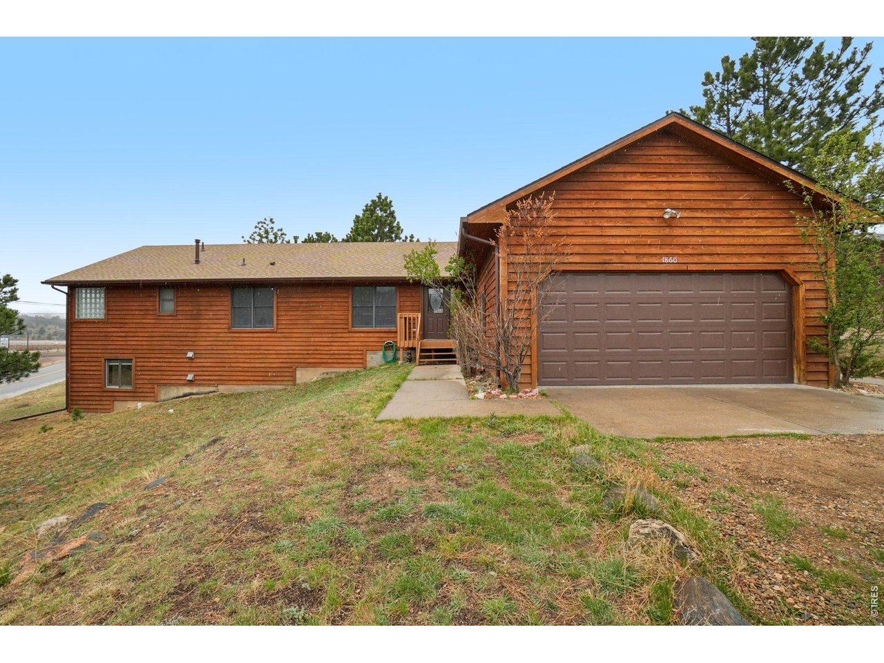 Experience the best of mountain living in this beautifully situated home at 1860 Raven Ave in Estes Park. Nestled among towering pines with breathtaking views of the surrounding foothills, this property offers a peaceful retreat just minutes from downtown and the entrance to Rocky Mountain National Park. Step inside to find a bright and welcoming interior with large windows that frame the natural beauty outside, filling the home with abundant light. The open-concept layout creates a seamless flow between the living, dining, and kitchen spaces, ideal for both everyday living and entertaining.The kitchen is thoughtfully designed with ample cabinetry, generous counter space, and a layout that keeps you connected to guests while preparing meals. The living area provides a comfortable place to unwind, with a warm and inviting atmosphere that perfectly complements the mountain setting. Spacious bedrooms offer restful retreats, while well-appointed bathrooms provide both function and style.Outdoor living is where this home truly shines. Enjoy morning coffee or evening sunsets from the deck while taking in the fresh mountain air and scenic surroundings. Wildlife sightings are a regular delight, adding to the charm and serenity of the location. Additional features include easy access to the lake. Whether you're looking for a full-time residence, vacation home, or investment opportunity, this property delivers the ideal balance of comfort, convenience, and natural beauty in one of Colorado's most sought-after mountain communities.