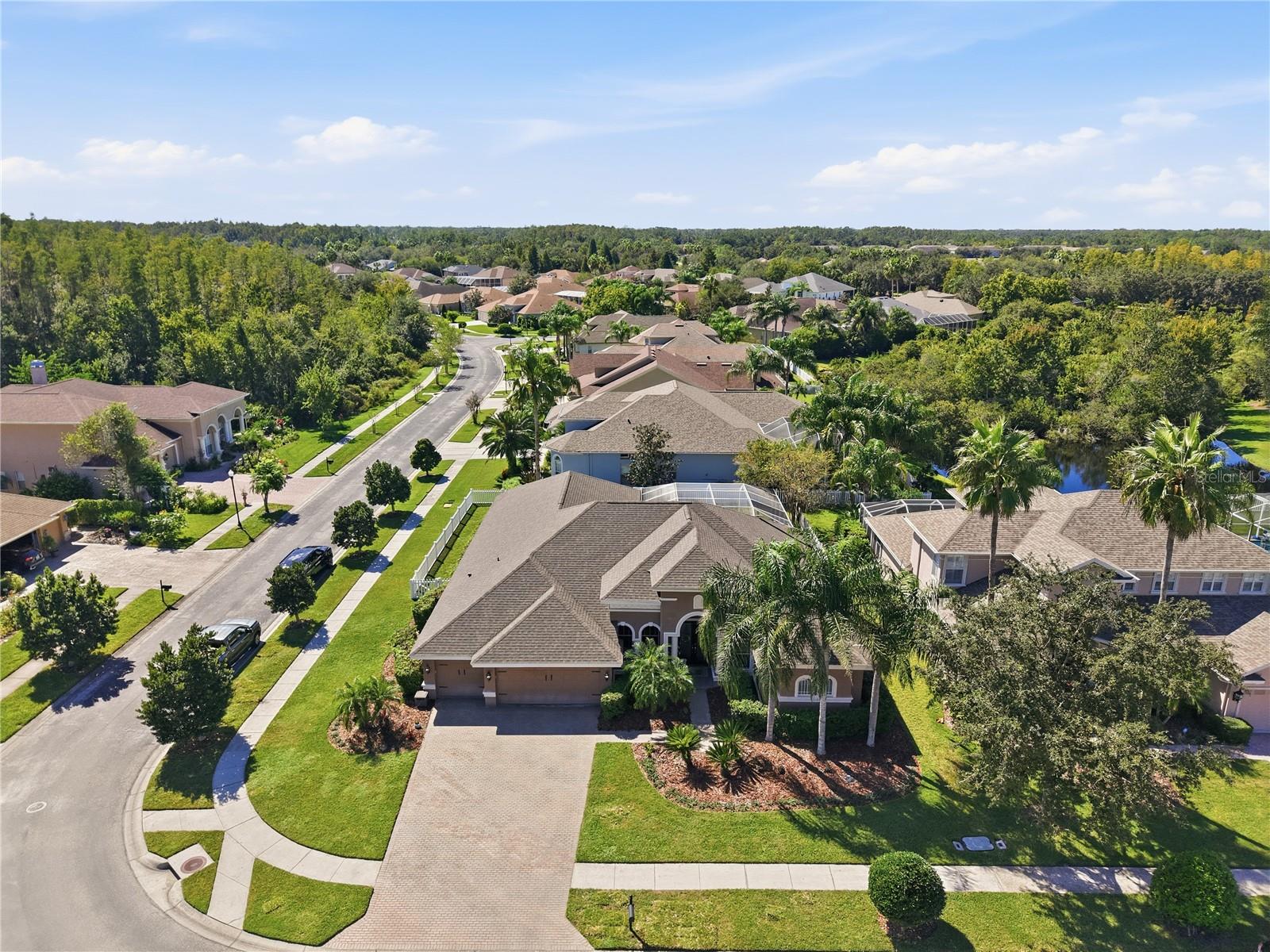 Welcome to Copperleaf, the gated enclave of Seven Oaks in Wesley Chapel, known for its privacy, larger homesites, and prime location. This well-maintained and updated home features 4 bedrooms, a dedicated office, formal living and dining rooms, a bonus room, 3 full bathrooms, and a 3-car garage. Situated on a corner lot with added side and backyard space, the home offers room to live, work, and entertain. The open floor plan includes formal living and dining areas, an office with French doors, and a spacious family room with triple sliding glass doors leading to the pool and lanai. Wood floors add warmth to the formal living areas, while the split-bedroom layout offers privacy between the primary suite and secondary bedrooms. The large white kitchen features 42-inch cabinets with custom storage, granite countertops, a center cooking island, and ample counter space. An eat-in nook with panoramic corner windows brings in natural light and offers a great view upon entry. The kitchen opens to the main living areas, making it easy to stay connected while cooking or entertaining. The primary suite sits at the front of the home and includes wood floors, a walk-in closet, and sliding doors to the pool area. The fully renovated primary bathroom features updated finishes. Three additional bedrooms and two full bathrooms sit on the opposite side of the home, while a rear bonus room offers space for a media room, playroom, gym, or extra living area. Enjoy outdoor living with a heated pool, spa, and covered lanai, ideal for relaxing or hosting guests. The corner lot provides extra outdoor space, while key updates include a 2023 roof, 2023 HVAC, whole-home water filtration, water softener, and reverse osmosis system. Copperleaf residents enjoy gated privacy within Seven Oaks, an established community with a low annual HOA and resort-style amenities. Features include multiple pools, a double-loop waterslide, children's splash park, fitness center, tennis courts, basketball, sand volleyball, soccer and softball fields, and a clubhouse with theater. Seven Oaks Elementary is within walking distance for many residents. Nearby sports and recreation include Wiregrass Ranch Sports Campus, AdventHealth Center Ice, Wesley Chapel District Park and Sports Complex, and the Mary W. Sierra Family YMCA. Enjoy easy access to I-75, SR 56, SR 54, and Bruce B. Downs Boulevard, plus shopping, dining, and entertainment at The Shops at Wiregrass, Tampa Premium Outlets, and The Grove. Hospitals and daily conveniences are also close by. Enjoy a pool home with space, updates, gated privacy, and resort-style amenities in one of Wesley Chapel's most established communities.