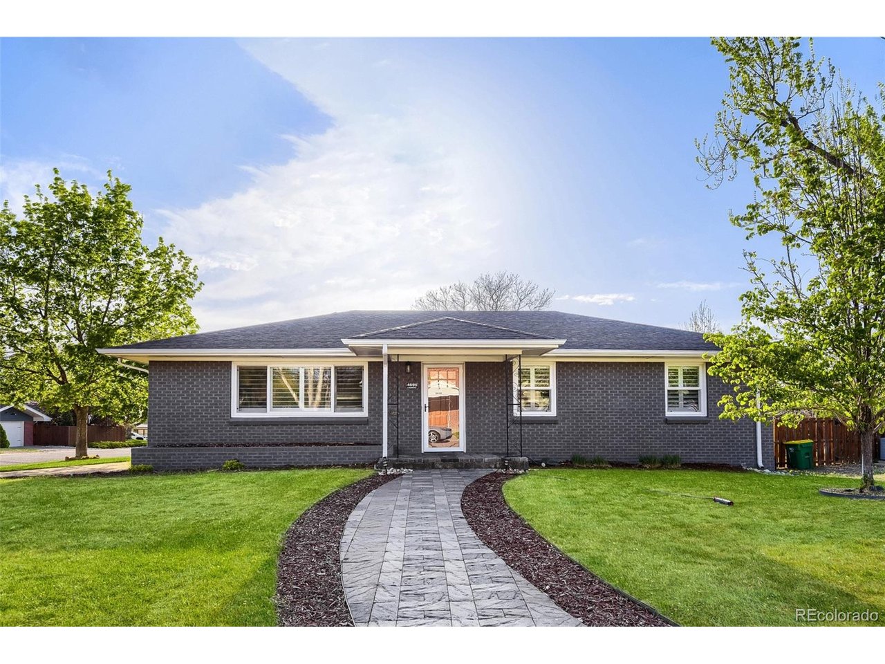 Perfect Blend of classic 1950's charm and modern living in this Beautifully Remodeled Home!  Built with Solid Construction and Quality Materials, this home features a Smart Floor Plan, Large Garage and an Ideal Location on a Quiet Corner Lot with a South-Facing Driveway - PERFECT for Sunny Colorado Winters!  Inside you will find an Open-Concept Main Floor with an Inviting gathering space for the Whole Family around the kitchen island that features High-Quality Kitchen Cabinets, Granite Countertops and Beautiful Hardwood Floors throughout the main floor.  Enjoy 3 generous bedrooms on the main level, including a Primary Suite with its own en-suite 3/4 bath (shower/toilet/sink).  All new Energy Efficient Windows with 5" Stylish Plantation Shutters make enjoying this large corner lot from inside our outside a Total Joy!  The Full Basement provides excellent flexibility with a 4th conforming bedroom and a large Family room ideal for a home theater or entertaining as well as a Large Utility Room with Rough-In Plumbing if your inclined to install another bathroom (or two) in the basement.  This home is in MOVE-IN condition and ready for you to make it yours!  Most Inside Photos Virtually Staged.  Showings Start Friday after 10 a.m. so book your showing NOW!