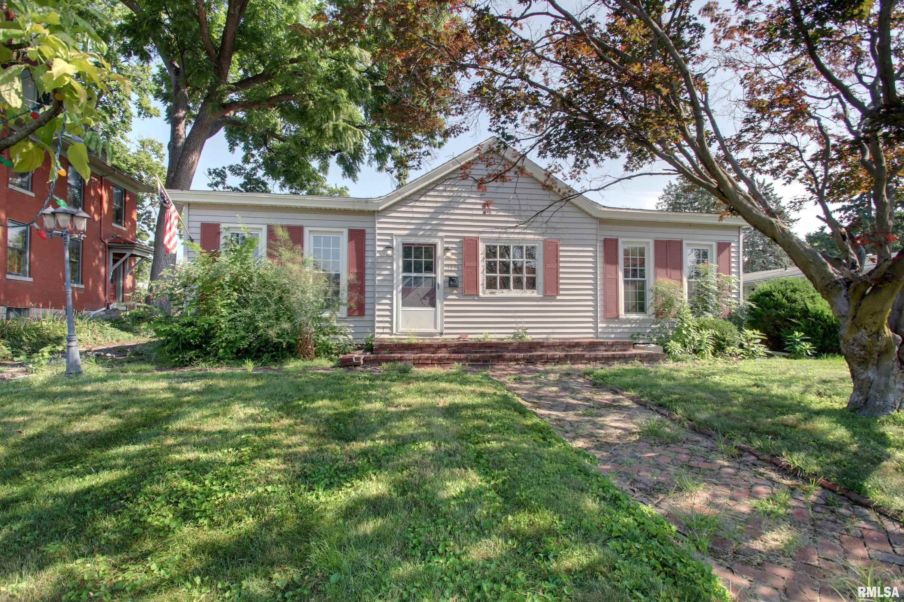 Tucked beneath mature shade trees on nearly a third of an acre, this four bedroom, one and a half bath ranch is brimming with cottage charm and thoughtful updates. A brick pathway welcomes you to the front door, and low-maintenance vinyl siding with classic shutters gives the home unmistakable curb appeal in one of Quincy’s most fabulous central neighborhoods.  Inside, brand new carpet flows through the bedrooms and living spaces, offering a fresh, neutral canvas ready for your personal touch. The bedroom feature charming brick accents, sturdy pine panelling for great texture and built-in shelving, adding character you won’t find in new construction. Double-pane vinyl replacement windows and updated HVAC mean comfort and efficiency are already taken care of.  The eat-in kitchen offers generous cabinet and counter space and flows into a fantastic pine-paneled family room with flagstone flooring and a built-in brick accent wall; a warm, rustic retreat that’s full of personality. With over 1600 sq ft there’s room for everyone, plus a large backyard for pets, play, or your next garden project.  This adorable adobe is full of character and ready for its next chapter!