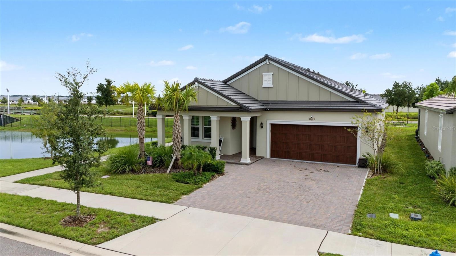 LET'S TALK ABOUT THE VIEW ON THIS EXCEPTIONAL HOME!!! GORGEOUS POND & WOODED VIEWS WITH ONLY ONE SIDE NEIGHBOR AND JUST STEPS AWAY FROM CLUB MEDLEY! Medley Active Adult for those better than 55 years young presents an exceptional lifestyle just beyond the confines of your home. As a resident, you'll enjoy exclusive Clubhouse access with a full calendar of events daily! You will also enjoy a grill & bar, heated pool w/cabanas, ballroom, billiards room, card room, state of the art fitness center, pickleball & tennis courts, bocce ball, yoga, bingo, card games, line dancing and private active adult events. PLUS included in your HOA is a 15-acre lagoon membership w/soft, sandy beaches including a swim-up bar, kayaking, paddleboarding, obstacle course, waterslides, corn hole games, and tons of community events! There is also a BRAND NEW TIKI HUT COMING SOON along with another set of amazing amenites! This IMMACULATE & HIGHLY UPGRADED home will please even the most selective buyers! Comprised of 2 spacious bedrooms, 2 full baths, and bonus room that could be used as an office or den. Primary Suite includes ensuite bath, dual sinks, walk-in shower and Walk-in Closet to keep you organized, ceiling fans to keep you cool. Spacious Laundry room opens into Primary closet which opens into Primary bath for your convienience. Your new home also has QUARTZ COUNTERTOPS throughout, UPGRADED STAINLESS APPLILANCES, walk-in pantry and abundant cabinetry. Numerous upgrades including: FULL GLASS FRONT DOOR, UPGRADED LIGHTING, CUSTOM DOORS ON DEN/OFFICE, UPGRADED APPLIANCES, FLOATING SHELF IN FAMILY ROOM, CUSTOM DOOR ON WATER CLOSET, ALEXA SMART HOME, DUST TO DAWN LIGHTS OVER GARAGE, MOTION SENSOR LIGHTS INSIDE, CUSTOM ELECTRIC BLINDS ON WINDOWS AND SLIDERS, UNDER BAR LIGHTING ON TILED CENTER ISLAND, UNDER CABINET LIGHTING, BACKSPLASH IN KITCHEN, WATER SOFTENER, EPOXY FLOOR IN GARAGE, LARGE LANAI HAS BEEN FULLY SCREENED for your enjoyment. Also included is a tiled roof plus a WIDENED and pavered driveway! Gorgeous curb appeal on this BLOCK HOME with a 2-car garage. As you step inside, you'll be greeted by a seamless flow of open living spaces, making it ideal for boWIth relaxation and entertaining. Get ready to make memories that will last a lifetime! Your dream home awaits; you will be enjoying the CAREFREE FLORIDA RESORT LIFESTYLE in your new home as quickly as you are able to move in! High-speed (ULTRAFI) internet, premium cable, yard maintenance & exterior painting are included by the HOA. Situated in close proximity to premier shopping destinations, and an array of dining options, you'll find yourself immersed in a vibrant community that strikes a perfect balance between exclusivity and convenience. Ride your Golf Cart to the Clubhouse, Publix, Chick-fil-a, Starbucks, Farmers Market and more right in the neighborhood! Close to Advent Health Hospitals, BayCare Hospital, Florida Medical Clinic, Wire Grass Mall, Tampa Premium Outlet Mall, Krate at the Grove, Sam's Club, Costco, Golf Courses & Movie Theater. Easy access to I75, 275, Tampa International Airport, Downtown Tampa and Florida's amazing beaches. CDD IS ALREADY INCLUDED IN TAX AMOUNT.