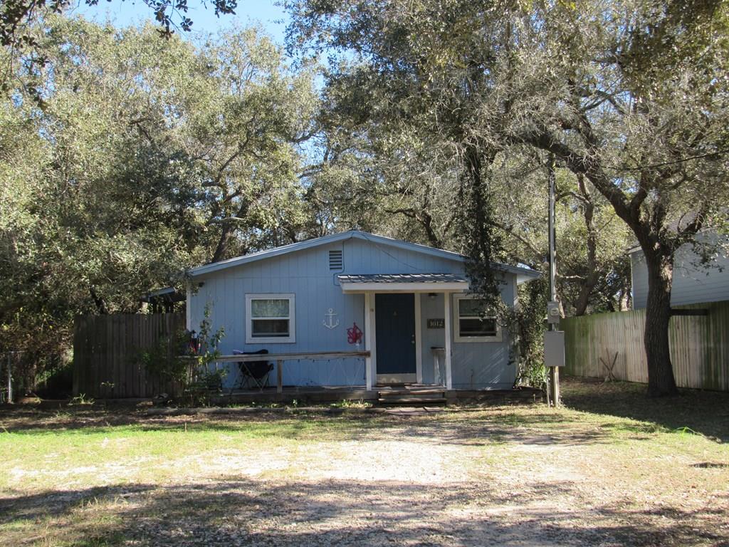Hang up your fishing poles and settle into this charming coastal cottage just minutes from Aransas Bay, Estes Flats, and Cove Harbor Marina. Situated on a deep lot, this home offers a breezy screened-in back porch&mdash;perfect for unwinding after a day on the water. Featuring a metal roof and HardiPlank siding. The bright kitchen boasts ample cabinet space, while updated flooring and two mini-split systems provide comfort year-round.  The fully fenced, oversized yard offers plenty of space for boats, an RV, and outdoor fun, with generous parking and room to roam.  A convenient storage shed in the backyard adds extra functionality. Whether you're looking for a weekend fishing retreat or a full-time coastal escape, this laid-back cottage delivers the perfect blend of comfort, convenience, and coastal charm.