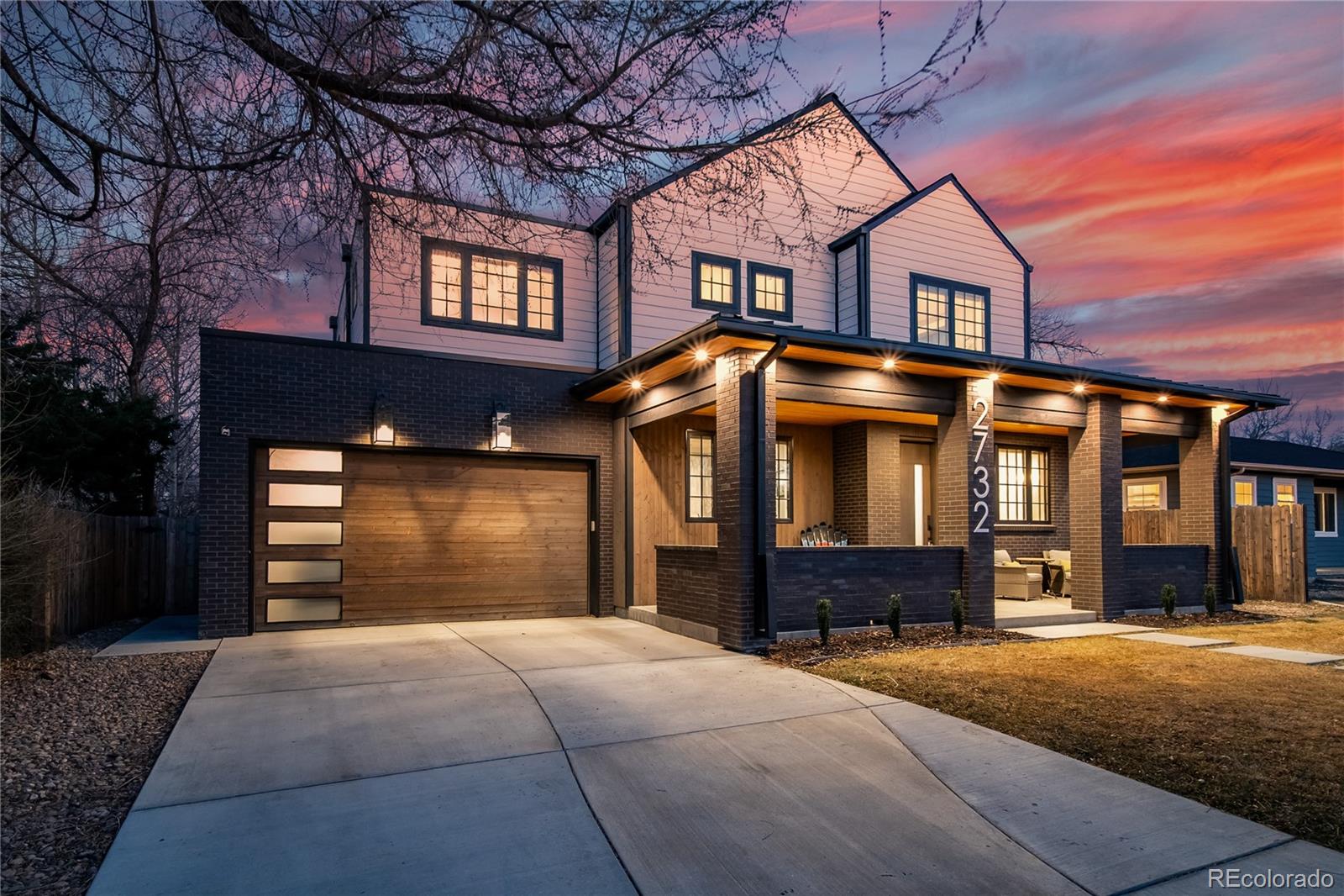 This masterfully curated home where modern design, craftsmanship, and indoor-outdoor living converge in Denver’s sought-after Slavens Elementary School District is a MUST SEE! The sunlight filled open floor plan, black-framed windows, paneled ceilings, and a bold open staircase create an unforgettable first impression. A full wall of glass opens to an expansive covered patio and private backyard, perfect for refined entertaining or everyday serenity. At the heart of the home, the designer kitchen is sure to impress with striking deep navy cabinetry, a contrasting white island with seating and storage, snazzy herringbone backsplash, double ovens, gas cooktop, french door refrigerator, two dishwashers, and additional beverage cooler. A butler’s pantry (with an additional enclosed pantry) leads to a formal dining room, surrounded by elegant wainscoting, and featuring a buffet space and wine refrigerator. The great room’s dramatic tiled gas fireplace with built in storage creates a perfect backdrop for gatherings large and small. The main floor also features a stylish private office framed by custom built-in bookcases and a serene guest suite with its own bath and patio access — ideal for guests seeking comfort and privacy. Upstairs, the primary suite is a luxurious retreat with a cozy fireplace, spa-like ensuite bath with a freestanding soaking tub, glass-enclosed shower, and dual vanities. The custom walk-in closet features a center island and storage worthy of a celebrity wardrobe, elevating everyday living to something extraordinary. Two additional bedrooms share a beautifully appointed Jack & Jill bath with double sinks, a freestanding tub, and a separate shower. The finished lower level offers a convenient wet bar with a full-size refrigerator and dishwasher, a spacious recreation room, a private guest suite, and a dedicated exercise room. Located near parks, trails, shopping, dining, and mere steps away from an incredible Saturday morning Farmer's Market!
