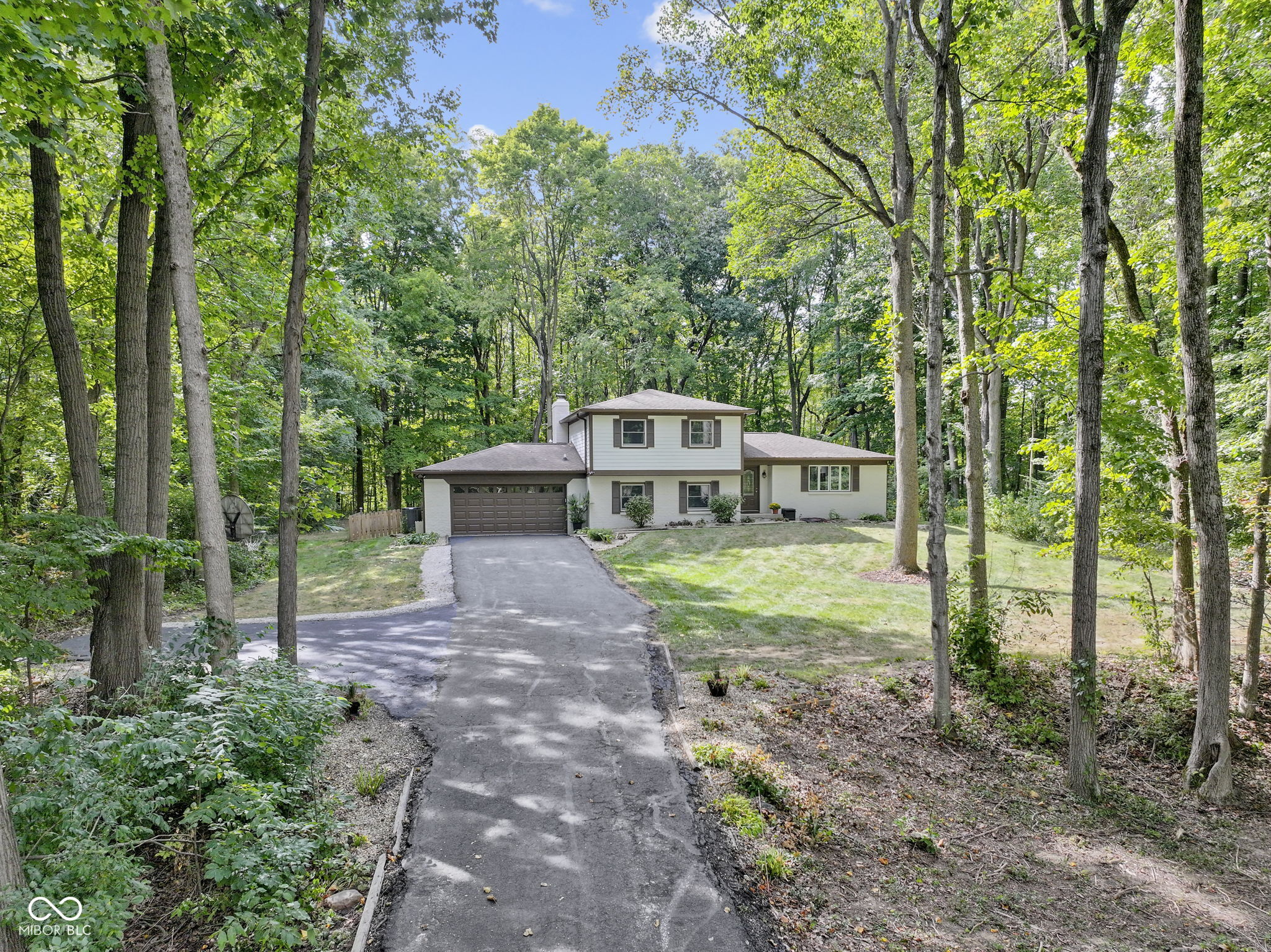 SEIZE THE OPPORTUNITY TO ESCAPE THE MUNDANE in this thoughtfully-reinvented classic, nestled on a wooded 1.2 ACRES, in a quiet cove of mature hardwoods and leafy privacy that is near-impossible to find these days. Gutted to the studs in 2023, this kitchen is just WOW!  Set aside all your preconceived notions of the stereotypical tri-level and come experience what a little vision and A LOT of investment has crafted!  If you recall the traditional design of a tri-level floor plan, with its old-fashioned tiny kitchen/dining/living room all on one floor (yuk!), you'll find that has all been TRANSFORMED here!  It's been brilliantly opened up and converted into one FANTASTIC central space for cooking & gathering around a MAGNIFICENT central island of custom cabinets w/ miles of granite that is truly the epicenter of this home.  Someone lucky will be the proud host for the holidays this year, as nobody else in the family is likely to have a space quite this large for the Turkey spread!  Other special things about this home would include the wonderful enclosed porch on the rear and the two large decks (one with a hot tub!), all of which help you absorb the tranquil, green environment that surrounds you.  Back inside, the convenient floor plan has the traditional three bedrooms on the upper level, but it also has a nice 4th on the main level that duals as a superb office, being close to the powder room and laundry area.  Finally, you'll find a fun basement here, which is, of course, the perfect man cave and winter escape.  Other recent updates to note:  renovated primary bath, fresh paint inside & out, new flooring t/o, driveway resealed, new water heater, water softener & holding tank.