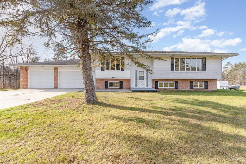 Discover the charm of country living on five beautiful acres in Midland County. This spacious nearly 3,000 sq. ft. home offers endless possibilities with 3 bedrooms, a dedicated home office/den, and a generous 2.5-car garage. The primary suite includes a walk-in closet and private half bath, while the large eat-in kitchen with oak cabinetry and a center island sets the stage for family gatherings. With two kitchens and two living areas, the layout is ideal for multigenerational living or entertaining with ease. Beyond the main home the property offers unique extras that add both versatility and charm: A mobile home provides additional space for guests or can serve as an income opportunity, while a finished shed creates the perfect retreat for a man-cave or creative studio. An expansive pole barn provides plenty of room for equipment storage or hobby space, making this property as practical as it is inviting. Whether you're seeking a place to expand or simply the peace of country living, this property offers it all. Schedule your tour today!