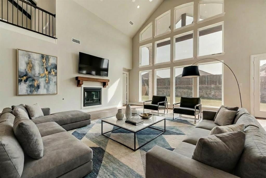 Stunning New Grand Home in Monterra – North-Facing Homesite in Rockwall ISDWelcome to this exceptional modern white brick home in the highly sought-after master-planned community of Monterra, zoned to acclaimed Rockwall ISD. Ideally situated just one block from the neighborhood pool and sport courts, residents enjoy resort-style amenities including a swimming pool, splash pad, scenic trails, basketball courts, and pickleball courts.A dramatic sweeping curved staircase with wrought iron railing creates an impressive first impression. The open-concept family room is filled with natural light from a wall of energy-efficient windows and features a gas fireplace and stylish dry bar, making it perfect for entertaining. The flexible floor plan offers a downstairs media room, a formal living area or private home office, an upstairs gameroom, and a bonus room ideal for kids or hobbies, along with a private downstairs guest suite for added convenience.The gourmet kitchen is beautifully appointed with a large island, two-tone Shaker cabinetry, slab countertops, stainless steel appliances, a five-burner gas cooktop, custom pots and pans drawers, a trash pull-out, and an oversized walk-in pantry. Throughout the home, you’ll find upscale finishes including 8-foot doors, wood flooring, thick designer trim, and flat-screen TV wiring.The luxurious primary suite offers a spa-inspired retreat with a freestanding soaking tub, glass-enclosed tiled shower, dual rectangular sinks with separate vanities, and a spacious walk-in closet with oversized tile flooring. Energy efficiency is a priority with R38 insulation and a tankless water heater as part of its Energy Star partnership.Enjoy outdoor living on the covered back patio, perfect for relaxing or entertaining guests. Conveniently located near shopping, dining, and recreation at Lake Ray Hubbard, this home delivers style, comfort, and an exceptional lifestyle opportunity.
