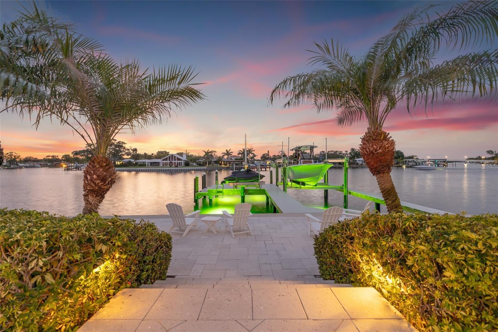 Coastal Waterfront Luxury on Snell Isle in the peaceful enclave of Eden Isle. (THIS HOME DID NOT EXPERIENCE ANY DAMAGE OR WATER INTRUSION FROM RECENT HURRICANES) Experience effortless coastal luxury living in this beautifully updated waterfront pool home with new seawall, dock and boat lifts. Perfectly positioned on Smacks Bayou with instant access to Tampa Bay, this exceptional residence offers a well-designed living space, featuring two private primary suites, a split floor plan, and seamless indoor-outdoor flow that defines the relaxed sophistication of St. Petersburg’s coastal lifestyle. From the moment you enter, you’ll appreciate the home’s versatile layout, which includes both formal and casual living and dining areas—perfect for hosting guests or enjoying quiet evenings at home. At the heart of the home, the thoughtfully designed kitchen blends functionality with elevated style. It features a large center island, custom wood cabinetry, stainless steel appliances, a wine refrigerator, and a convenient pass-through window to the covered lanai—ideal for entertaining and everyday living. The main primary suite is a peaceful and private retreat, offering two generous walk-in closets and a newly updated en suite bathroom with dual sinks and a spa-like glass-enclosed shower. The second primary suite—ideal as a guest suite, home office, or den—features a charming bay window that perfectly frames stunning water views, an en suite bath that also serves as a convenient pool bath, and its own private space tucked away for comfort and flexibility. Step outside and embrace the ultimate St. Pete lifestyle from your own tropical oasis. Watch dolphins and manatees play in the bayou as you sip your morning coffee, or unwind in the evening with a cocktail and a vibrant sunset. The outdoor space is designed for year-round enjoyment, featuring a resort-style pool and spa, a fully equipped outdoor kitchen, and lush, private landscaping. A newer paver walkway connects the pool area to the dock, completed in 2022, which features a 16,000 lb boat lift and a 1,500 lb PWC lift—your personal launch point to Tampa Bay, the Gulf beaches, or a quick boat ride to downtown St. Pete or Tampa. Additional upgrades include impact-rated windows and doors throughout, a new seawall, a new paver driveway and front porch (2022), a four-zone AC system installed in June 2024 and all new PVC pipe installed. *** Best of all, this home has had no water intrusion during recent hurricanes ***  a valuable reassurance for waterfront living. Ideally located just minutes from everything that makes St. Pete one of Florida’s most desirable coastal cities, this home allows you to take your golf cart downtown for Michelin-starred dining, sidewalk cafés, boutique shopping, world-renowned museums, the St. Pete Pier, and miles of scenic waterfront parks. Everyday conveniences like Whole Foods, Trader Joe’s, Publix, and Fresh Market are all nearby along the vibrant 4th Street Corridor. Whether you’re searching for a full-time residence or a luxurious waterfront retreat, this exceptional home perfectly captures the essence of modern coastal living in the heart of St. Petersburg.