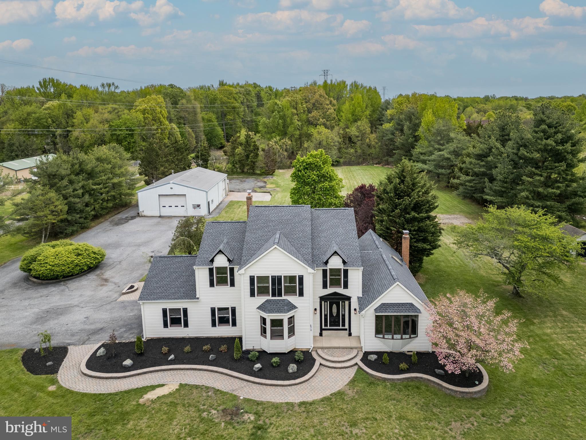 An exceptional opportunity to own a beautifully updated 3,730-square-foot home nestled on approximately 4.4 private acres just off Hartford Road in Medford Township across from Lenape High School. This impressive property offers 4 bedrooms, 2.5 bathrooms, an attached 2-car garage, a massive 60' x 40' detached garage, a partially finished basement, a stunning paver patio with a fire pit, and a picturesque private pond.Recent upgrades include a new roof, new HVAC system, newly installed gas service, fresh interior paint, new lighting,  new laminate flooring, and new carpeting.  Additionally,  there are Andersen windows and a central vacuum system.Step inside to a spacious foyer that welcomes you into the home. The formal dining room is situated to the left, while the formal living room is located to the right. The heart of the home is the inviting family room, featuring vaulted ceilings, exposed painted beams, a fireplace, and direct access to the expansive paver patio overlooking the peaceful backyard and pond.The beautifully renovated eat-in kitchen showcases new cabinetry, quartz countertops, custom backsplash, a center island, double ovens, and abundant space for gathering and entertaining. A convenient first-floor laundry room and powder room complete the main level.Upstairs, the spacious primary suite offers a luxurious, newly updated en-suite bathroom featuring a soaking tub, double vanity, custom-tiled walk-in shower, and dedicated makeup vanity. Three additional generously sized bedrooms and a full bathroom complete the second floor.Outside, a 1,000-foot driveway leads to the impressive detached garage, which has its own electric meter and offers endless possibilities for hobbyists, contractors, collectors, storage, or a future workshop.Combining privacy, modern updates, and exceptional indoor and outdoor living spaces, this unique property delivers the perfect balance of comfort, functionality, and opportunity. Outstanding Medford township schools and convenient to major roads and shopping.  Seller is a licensed NJ real estate agent.
