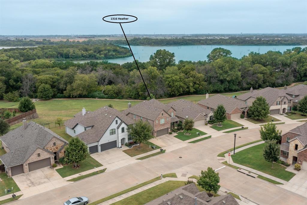This home is better than new! Seller thought this would be her forever home and has put in upgrades not usually found at this price point. She had to move for work. Her loss is your gain! Set in a great location, this lovingly cared for home backs to a five mile walking & biking trail along the shores of Lake Lewisville. Expansive views are yours in the winter and there are various access points on the path, which will also take you to one of Paloma Creek's many amenities centers & pools. If you haven't visited yet, you'll love this master planned community which features splash parks, 4 pools, 2 gyms, club houses, 1500 acres of wooded area, seven playgrounds, a large dog park & a multitude of special interest clubs & activities for the whole family. Now about this fabulous house! Meticulously cared for and gently used, this home is beautiful inside and out. It feels so clean & well kept & the seller has added so many features for your comfort. Where to start? The generator will give you peace of mind. This big ticket item will ensure you never are without power. The whole house water filtration system is better and safer than any Brita or fridge filter on the market. The 3 car garage has epoxy floors. The pantry has been customized with beautiful LED lights and upgraded shelving. The media room has gorgeous architectural detail & all of the projection equipment stays for your ease and enjoyment! Outside, over $100,000 was invested in adding irrigation, drainage, raised beds, landscaping & hardscaping. Not only is it beautiful, it is functional. You should never experience foundation concerns. The seller has made this a one of a kind property. You will feel the luxury from the moment you drive up & you will be truly fortunate to call 1316 Heather home.