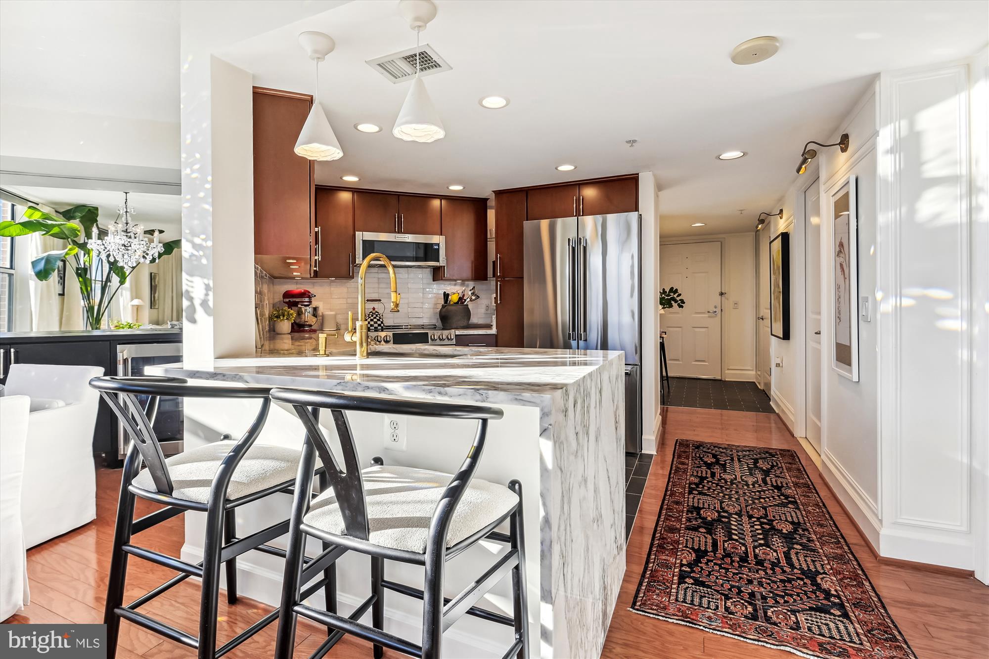 This 2 Bedroom 2 Bath condo across from Reston Town Center has been renovated for a discerning buyer who appreciates luxury.  Located on the 6th floor with beautiful views all the way to Tysons Corner. Shining hardwood floors on main living area, tile in the kitchen and carpeted bedroom's. The kitchen went through extensive renovation in 2022 making it stand out from other units by far. Lots of storage with a deep cabinet over the refrigerator and a built-in pantry. Undercabinet lighting brightens up the kitchen top work areas. Dining room has a custom built in cabinet beneath the built-in mirror. A very convenient built-in cabinet under the TV. There is a balcony off the Living Room large enough for chairs and small table. When you walk around the condo, you will find the seller has made wonderful use of all the hidden away spaces with cabinets, shelves, built-ins etc. Washer and dryer are large capacity units that were recently replaced. New HVAC installed in 2020 and new Water Heater in 2022! Condo comes with 2 parking spaces in the garage and they are very convenient to the elevator. Fabulous amenities included in the condo fee are a rooftop pool, veranda with outdoor grilling stations and dining terrace. Breathtaking views from the roof top club room with full kitchen, bar and separate billiards room. Theater room, a well equipped fitness center, coffee bar area and business center. You can walk to Reston Town Center within a couple of minutes where there are a multitude of restaurants, shops, movie theatre, ice-skating and summer outdoor concerts . Whole Foods Market at Plaza America and then Wiehle metro and the near future Reston silver line is close by. Right outside the Carlton House is the W & OD trail . The Carlton House is a pet friendly building with restrictions. This is a secure entry building. Entire list of upgrades will be provided as an added document in the MLS.