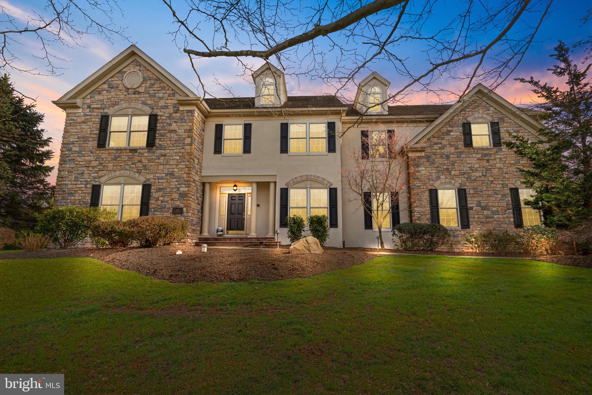 Welcome to 1310 Prospect Farm Drive nestled on a quiet, cul-de-sac, located in the award-winning Pennsbury School District and highly sought-after Lower Makefield Township.  Enter this stunning stone-front home into the grand foyer, with gleaming hardwood floors flowing through much of the main level. Your eye will be immediately drawn to the soaring ceilings and abundant natural light then toward the freshly painted formal dining room complete with chandelier that is a true statement piece.  You will be proud to host friends and family in this elegant space. Beyond the dining room you'll be welcomed into nicely sized eat-in kitchen with hardwood floors, timeless wood cabinetry, granite counters, new stainless steel appliances, large island with seating, walk-in pantry and room for a kitchen table.  The kitchen opens to a bright family room highlighted by a striking two-story, wood-burning stone fireplace, this room is sure to be your new favorite gathering place.  The main level of the home also features a designated office with French doors, built-in desks with ample storage.  A formal living room adds versatility, whether used as an additional seating area, playroom or a second office. Completing the main floor is a powder room as well as laundry/mud room with access to the 3-car garage.  A convenient dual-access staircase with entry points from the foyer and kitchen will lead you to the second floor. There, a spacious primary suite features large walk-in closet with dressing area and ensuite with double sink, stand-alone shower, jacuzzi tub and updated fixtures.  Three additional generously sized bedrooms complete the second level.  One bedroom features a private ensuite, while a third full bathroom is accessible from both the hallway and a secondary bedroom. The home continues to impress with a full basement offering two expansive areas, one finished for additional living space and the other ideal for storage and housing the utilities including: media rack for the whole-house audio system, 3-zone HVAC system and pre-wiring for a generator.  The exterior of the home is equally exceptional, featuring elegant Travertine Pavers for the front and rear walkways as well as private backyard patio designed for entertaining.  The courtyard style seating area with half wall, built-in grill and ambient lighting.  Adjacent to the patio is spacious deck with sliding glass door access to the kitchen.  This private backyard retreat offers the perfect setting to host and enjoy.
