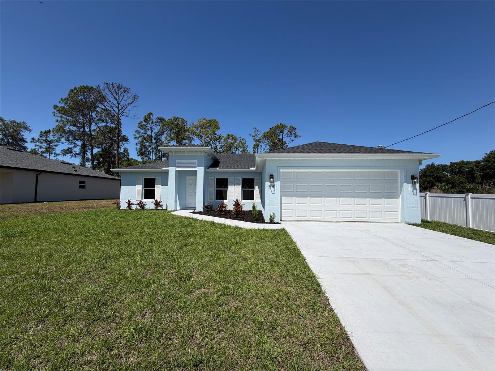 One or more photo(s) has been virtually staged. BEAUTIFUL NEW CONSTRUCTION HOME - AVAILABLE NOW!Why settle for a basic "builder grade" home when you can have it all included? This stunning home offers a level of upgrades rarely seen at this price point. Featuring an open, split floor plan with vaulted ceilings, this home is built for both style and long-term savings.PREMIUM FEATURES INCLUDED: This home is fully equipped with PGT double-pane Hurricane Impact windows and sliding doors, meaning NO shutters are ever needed. You will find 50-year-rated porcelain tile flooring throughout the entire home, including the showers. The chef-inspired kitchen features 36-inch upper cabinets with soft-close drawers and doors, premium granite or quartz countertops, and quality stainless steel appliances.BUILT FOR SAVINGS AND DURABILITY: Designed to keep your insurance, maintenance, and utility costs at a minimum, this home includes an energy-efficient HVAC system, a 3- or 4-zone sprinkler system and a 30-year shingle roof. The exterior comes fully sodded and professionally landscaped, complete with gutters around the entire perimeter and a fully screened-in lanai for year-round Florida living.PEACE OF MIND: Move in with confidence knowing your investment is protected by extensive warranties, including a 10-year structural warranty and a 10-year HVAC warranty.FINANCING BONUS: Our preferred lender is currently offering up to $1,500 in closing cost assistance!Take a virtual tour of one of our beautiful homes here: https://youtu.be/SFsL-Aell24
