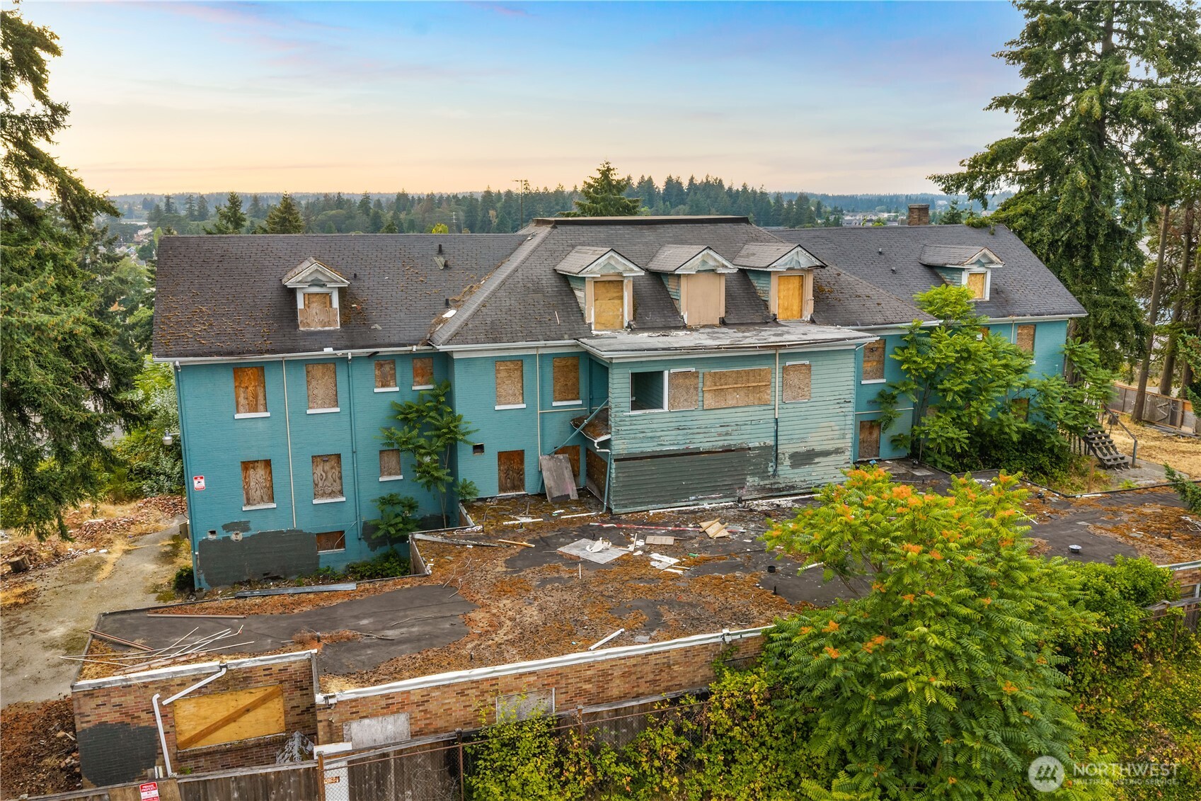 A rare Tacoma redevelopment opportunity with enormous potential. This historic property offers an expansive nearly 3/4 acre lot with a 37 unit configuration, creating an exceptional canvas for an investor, developer, or visionary buyer. Currently vacant and in need of a complete renovation, this property is ready for someone to bring imagination, creativity and strategic vision to its next chapter. Listed on the Historic Register, the property offers distinctive character and architectural significance alongside incredible development potential. A conditional use permit will be required. Conveniently located near the Tacoma Mall, major freeways, restaurants, shopping, and everyday amenities, the location offers both accessibility and strong surrounding infrastructure. The combination of scale, location, historic character makes this a truly uncommon opportunity.
