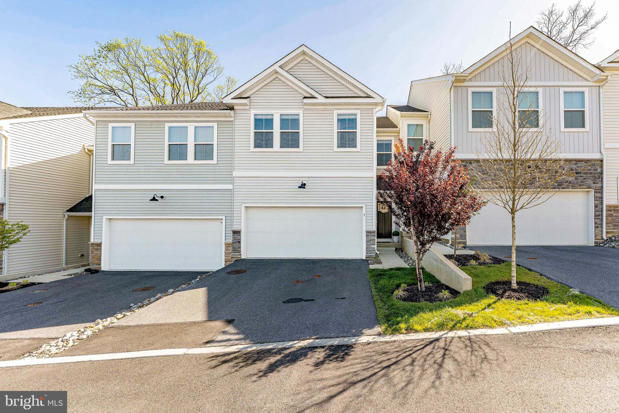 Welcome to 7 Four Leaf Drive, a 3-bedroom, 2.5-bath townhouse in the Clover Mill community of Downingtown. As you enter, the foyer features luxury vinyl plank flooring and leads to a conveniently located powder room with a modern accent wall. The main living area offers a bright and open layout. The living room includes sliding doors that lead to a composite deck, providing a great space for relaxing or entertaining. The dining area features a chandelier and is enhanced by a built-in sprinkler system for added peace of mind. The kitchen is well-appointed with quartz countertops, a center island with seating and a sink, Whirlpool stainless steel appliances, and a pantry. Additional features include a coat closet and direct access to the garage for everyday convenience. Upstairs, a versatile sitting area provides additional living space. The primary bedroom features carpet flooring, an accent wall, and a walk-in closet. The en-suite bathroom includes tile flooring, a double sink vanity with a seamless countertop, a step-in tiled shower, and a linen closet. A conveniently located laundry room with a front-load washer and dryer is also on this level. Two additional bedrooms, each with carpet flooring and walk-in closets, offer flexible space for family, guests, or a home office. A full hall bathroom with tile flooring and a tub and shower combination, along with an additional linen closet, completes this level. The unfinished lower level houses the home’s utilities, including a water softener, and offers the opportunity to be finished for additional living space. Conveniently located near local shopping, grocery stores, restaurants, and more, this home offers both comfort and accessibility. Don’t miss the opportunity to make 7 Four Leaf Drive your new home.