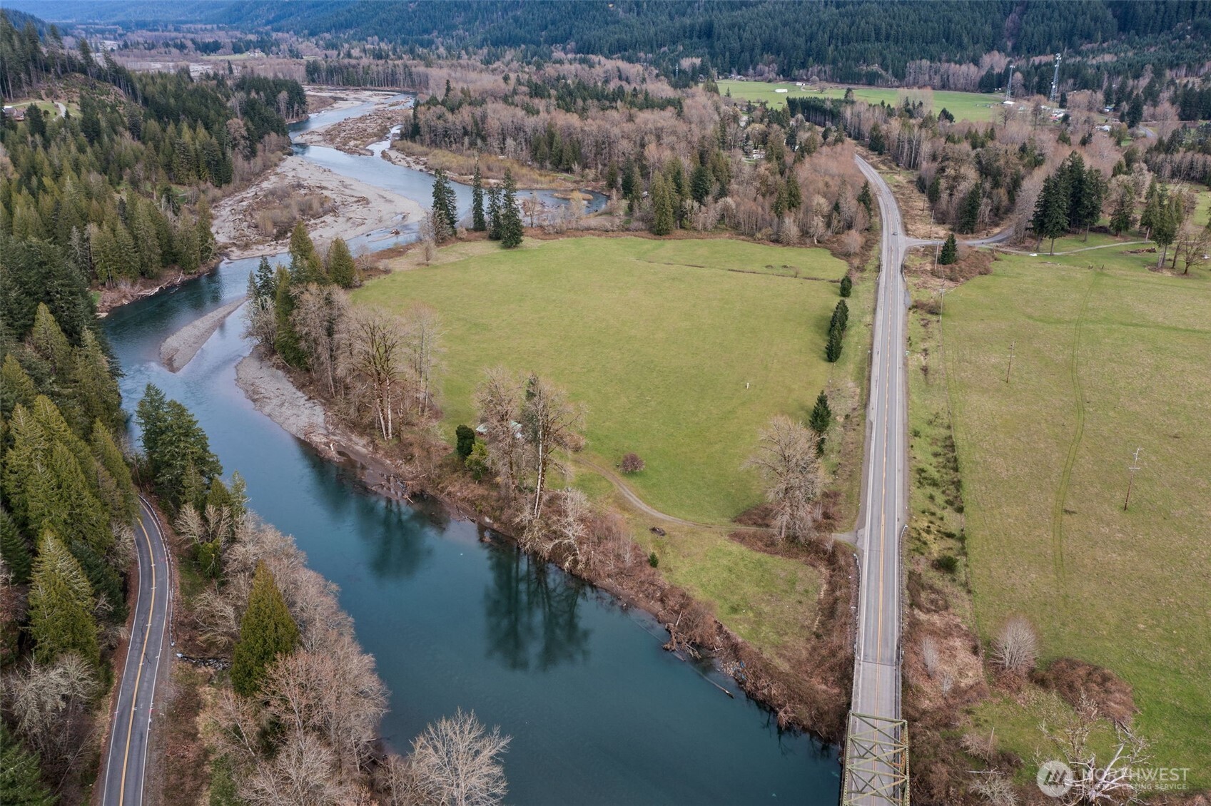 Escape to 30+ acres of rare riverfront paradise on three parcels with over 2,300 feet of frontage on the Cowlitz River, and your own private beach! On the east side, more than 1,500 feet of Garret Creek winds around the edge of the property, creating a truly unique retreat. Expansive territorial views, open skies, and plentiful wildlife define this one-of-a-kind setting.    A historic ~1900 homestead offers rustic charm with original lapboard walls and hints of antique wallpaper. With updated electrical and a pellet stove, it’s best suited as a cozy “glamping” cabin or basecamp for your outdoor adventures.    The property includes lush hayfields, mature timber, and a fenced garden with raised beds. Long-standing water rights from a gravity-fed spring (est. 1910) have been placed in trust; future residential building will require installation of a well. Power is available at a scenic camping and picnic area.    Ideally located near Mount Rainier National Park and White Pass Ski Area, this is the perfect setting for those seeking recreation, privacy, and a deep connection to the land.