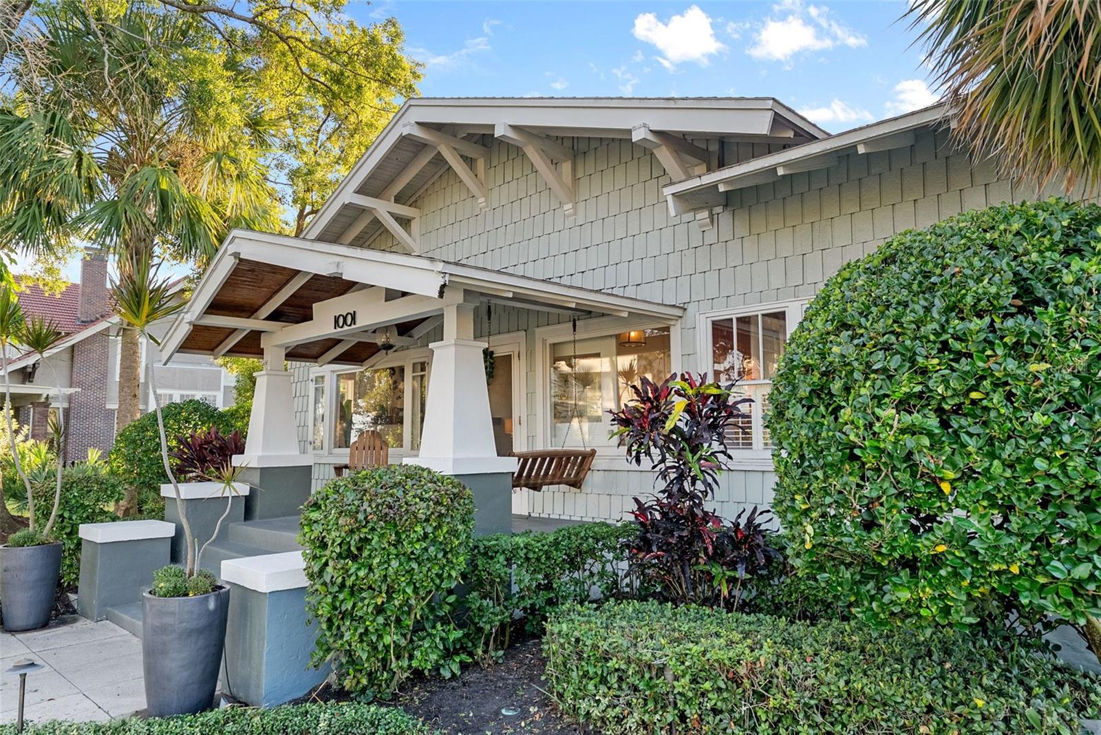 Under contract-accepting backup offers. Welcome to 1001 South Oregon Avenue, a stunningly restored and reimagined historic bungalow nestled on a coveted corner lot in the heart of Tampa’s most prestigious neighborhood—Hyde Park Village. Offering the perfect blend of classic charm and contemporary luxury, this five-bedroom, four-bath residence is a rare architectural jewel with panoramic views of the Bay and effortless access to the neighborhood’s premier dining, boutique shopping, and entertainment. From the moment you arrive, the expansive front porch invites you into a home where craftsmanship, elegance, and thoughtful design meet. Step through the historic wood front door into a light-filled interior curated by renowned designer Thomas Lamb, where smooth plaster walls, a soft neutral palette, and refined finishes offer a fresh, timeless canvas anchored by the home’s original architectural details. Soaring vaulted ceilings, an original wood-burning fireplace, and rich millwork nod to the home’s historic roots, while custom upgrades—including a corner sunroom/office with built-ins and natural wood walls, a generous formal dining space, and a chef’s kitchen—deliver modern-day functionality. The kitchen is a showpiece in itself, featuring a Sub-Zero refrigerator, Viking range, Bosch dishwasher, wine fridge, ice maker, second prep sink, and an antique mirrored backsplash that adds a touch of old-world glamour. Designed for seamless indoor-outdoor living, the backyard retreat features a clean-lined pool and spa, lush artificial turf, a side garden with Italian gas-fired pizza oven, and a screened-in porch with a fully equipped custom wet bar—perfect for entertaining under the stars. The home’s layout offers flexibility and privacy: there are three bedrooms and two baths on the main level, two of the bedrooms share a bath and the other has its own ensuite bath. Upstairs, the primary retreat serves as a serene sanctuary with tons of natural lights and views of the bay and dual walk-in closets, a linen closet, a private laundry, and a spa-inspired bath with double vanities, a glass walk-in shower, and a freestanding soaking tub. A newly built two-car garage with abundant storage sits at the rear of the property, topped by a private guest apartment featuring its own living room, bedroom, full bath, and washer/dryer—ideal for visitors, in-laws, or an au pair. This exquisite property spans 3,458 square feet, including 2,978 SF in the main house and 480 SF in the guest apartment, and is located in the highly sought-after Gorrie, Wilson, and Plant High School districts.