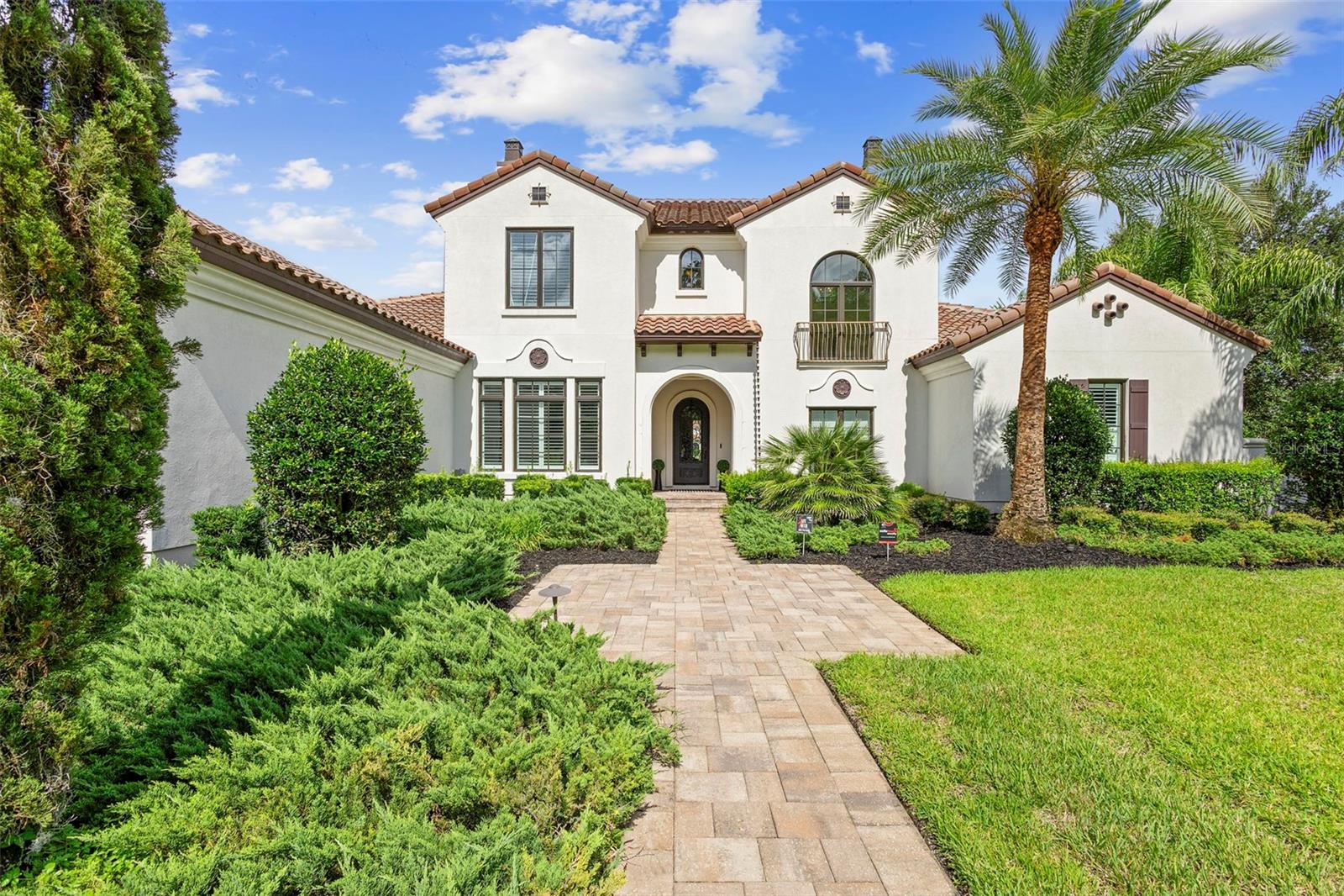Located within the exclusive guard-gated community of Pablo Creek Reserve in Jacksonville, FL, this well-appointed custom Mediterranean-style estate offers the perfect blend of luxury, functionality, and timeless design. Boasting 5 BEDROOMS, 5.5 BATHROOMS, a 3-CAR GARAGE, and over 4,800 SQFT of elevated living space, this home is designed for both grand entertaining and comfortable everyday living. The heart of the home is the chef’s kitchen, a dream for entertainers and culinary enthusiasts alike. Featuring dual islands, two farmhouse sinks, two dishwashers, TWO HIGH-END REFRIGERATORS, a gas cooktop with custom range hood, wet bar with wine fridge and ice maker, walk-in pantry, and new quartz countertops—this space is thoughtfully crafted for both form and function. The open-concept living area showcases new luxury vinyl plank flooring, a gas fireplace with floating built-ins, and gorgeous views of the pool and tranquil water beyond. Just off the main living area is the moody, design-forward primary suite, completely blacked out for serenity, with oversized drapes, tray ceiling, and an en-suite spa bathroom featuring dual vanities, a steam shower, and an oversized walk-in closet with built-ins and a center island ideal for watches, jewelry, or outfit planning. The first-floor office offers built-in cabinetry, French doors, and a shared view of the impressive saltwater pass-through fish tank. Nearby, you'll find a designer half bath, stylish mudroom cubbies, and a functional laundry space off the hallway leading to the garage. A versatile fifth bedroom on the main floor, currently used as a card room, offers direct access to the expansive covered patio. Outdoors, enjoy travertine tile flooring, built-in speakers, and a full summer kitchen, all overlooking the saltwater pool and spa. A bug-misting repellent system lines the gutters and fence for ultimate outdoor comfort. Upstairs, you'll find a spacious loft, three additional bedrooms—each with its own en-suite bath, and a second laundry room with space for stackable washer/dryer. Featuring a WHOLE HOME GENERAC GENERATOR this property is sure to give you peace of mind in the event of a power outage. This exceptional property is a rare opportunity to own in one of Jacksonville’s most coveted communities, where luxury meets thoughtful design in every detail. Call to schedule your private tour today!