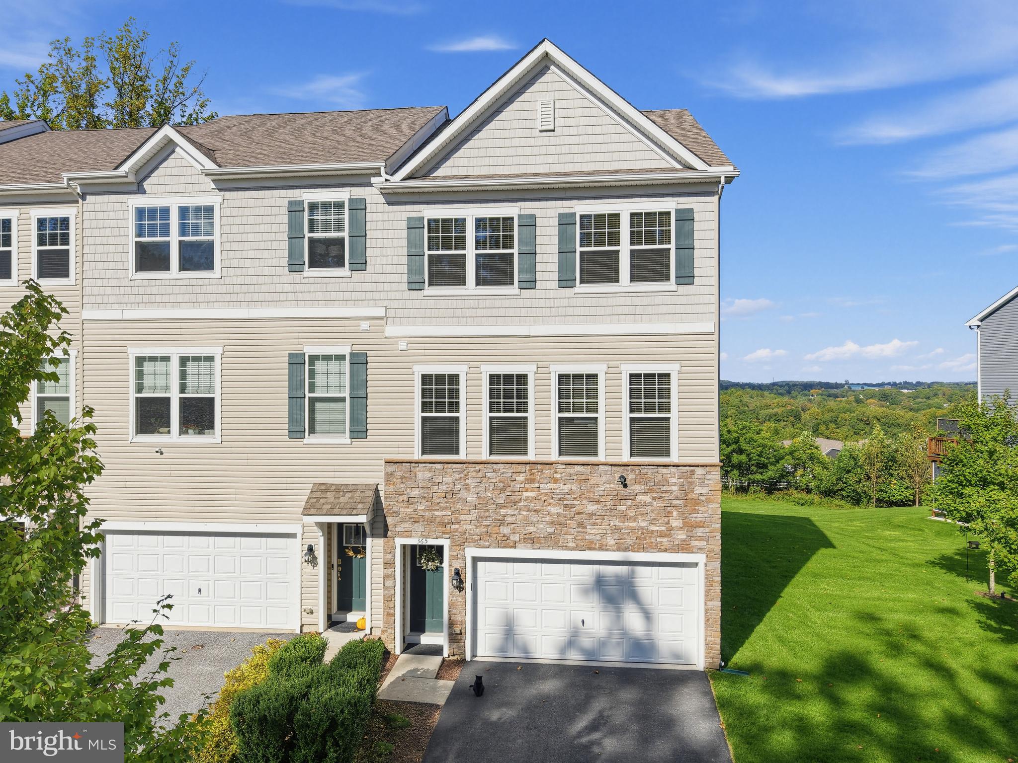 Welcome to an exceptional opportunity in sought-after Dowlin Forge Station! Perfectly positioned on a premium end-unit lot, this beautifully upgraded townhome enjoys truly extraordinary views, an impressive backdrop more reminiscent of a mountain retreat than a neighborhood setting. Combined with abundant natural light, a spacious open floor plan, and several upgrades rarely found within the community, this home stands apart from the moment you arrive.The main level was designed for both comfortable everyday living and effortless entertaining. At its heart is a beautiful enclosed gas fireplace, a unique feature and the only one of its kind in the community, bringing warmth and character to the expansive great room. The handsome kitchen features crisp white cabinetry, quartz countertops, a tile backsplash, stainless steel appliances, an oversized pantry, and a large center island offering plenty of room for gathering. An adjoining dining area opens through sliding glass doors to the deck, where those spectacular views become the perfect backdrop for morning coffee, evening cocktails, or outdoor dining. High ceilings and an abundance of windows, enhanced by the end-unit location, flood the entire level with natural light and create an exceptionally bright, open, and airy atmosphere. A convenient powder room completes the main level.The finished, at-grade lower level adds tremendous versatility and another feature that distinguishes this home from others in the community. Here you will find a spacious family room with sliding doors opening directly to the rear yard, along with a full bathroom, an uncommon and valuable upgrade that makes this level ideal for guests, entertaining, a home office, or additional living space. Interior access to the two-car garage completes this level.Upstairs, retreat to the spacious primary suite featuring an exceptionally large walk-in closet and an upgraded primary bath with a walk-in shower, dual-sink vanity, and private water closet. Two generously sized guest bedrooms share a well-appointed hall bath, while the conveniently located laundry room includes a built-in folding table for added functionality.Freshly painted throughout in neutral tones and enhanced with new upgraded carpeting, this home is truly move-in ready.And the location is every bit as impressive as the home itself. Enjoy the highly regarded Downingtown Area School District along with convenient access to Downingtown Borough and its train station, the Pennsylvania Turnpike, major commuting routes, shopping, dining, and the recreational opportunities of Marsh Creek State Park.Premium lot. Exceptional end-unit location. Two-car garage. Gas fireplace. Three full levels of finished living space. Extraordinary views. This is not simply another offering in Dowlin Forge Station, it is one of the community’s truly special homes.
