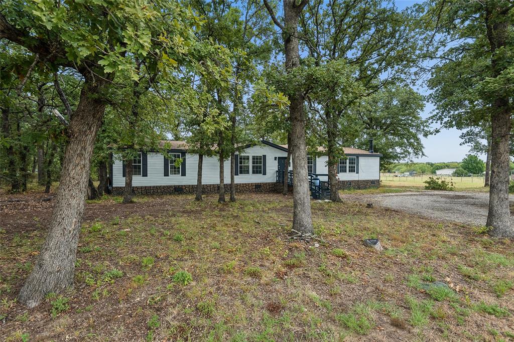 Charming manufactured home nestled among mature oak trees on expansive grounds