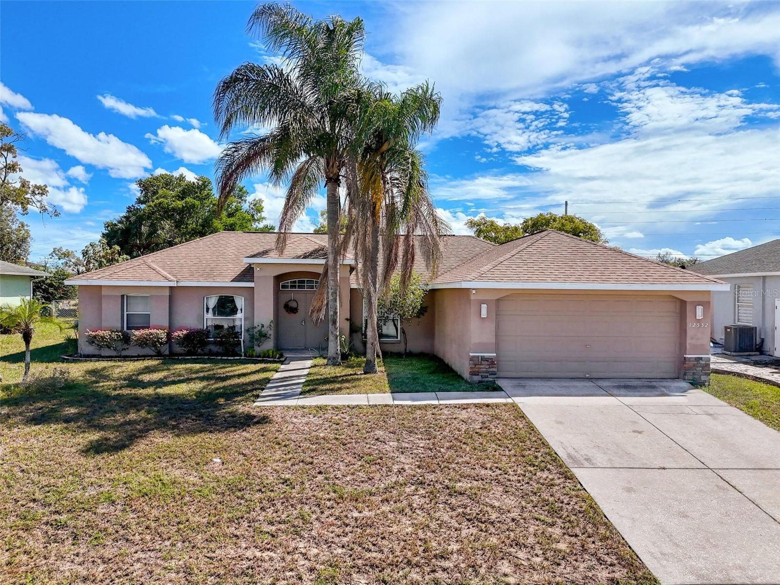Welcome to this beautiful 3-bedroom, 2-bathroom home featuring a 2-car garage and a spacious, functional split floor plan. The inviting interior offers high ceilings, an inside laundry room, and a large kitchen perfect for cooking and entertaining. Step outside to your own private oasis — a screened lanai overlooking a sparkling inground pool and a separate spa, ideal for relaxing or hosting gatherings. The fenced yard provides both privacy and plenty of space to enjoy the outdoors. Located in a desirable area close to restaurants, medical facilities, and major roads for an easy commute. No flood zone and no CDD — just the perfect combination of comfort, convenience, and peace of mind.