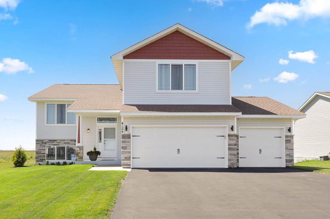 Welcome home! From the moment you step inside, the welcoming entry sets the tone for this beautifully designed 3-bedroom, 2-bath home. The main level features LVP flooring throughout the main area, creating a warm and inviting flow between the living room, dining area, and kitchen. The kitchen offers stainless steel appliances, a pantry, and a spacious center island with plenty of room for gathering. Just off the dining area, enjoy the opportunity to create your own outdoor space with a future deck overlooking the backyard.Two comfortable bedrooms and a full bathroom are conveniently located on the main level, while just a few steps up you'll find a private primary retreat complete with a walk-in closet and its own bathroom. The walkout lower level offers even more potential, with plenty of room to add one or two additional bedrooms, create a spacious family room, and enjoy a dedicated laundry area. The opportunities are endless!Outside, the backyard provides beautiful views and a great space for entertaining, relaxing, or enjoying the summer nights. The 3-stall garage is a standout feature with an epoxy floor, excellent storage cabinetry, and is insulated - perfect for Minnesota winters. With a functional layout, room to grow, and thoughtful spaces throughout, this home offers the perfect blend of comfort, flexibility, and convenience.