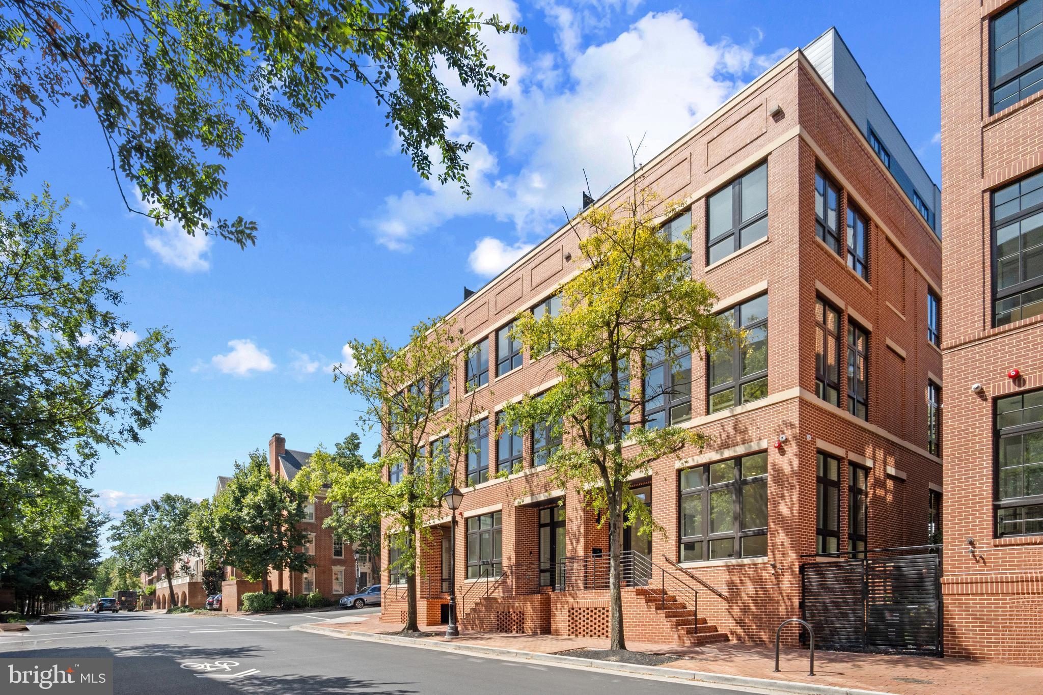 Situated on Old Town Alexandria’s most prestigious street, this River Row Elevator Residence at 223 South Union Street is the last available home of the six newly constructed, LEED Gold-certified homes redefining luxury living along the Potomac River. Developed by the visionary JC Development, this four-level residence offers a rare fusion of refined design, advanced engineering, and an unbeatable waterfront location—with no HOA or condo fees. Crafted from solid steel and concrete and wrapped in classic brick, the residence spans 3,366 square feet and rises four stories via a private elevator.  Architectural integrity is evident throughout with 12-foot ceilings, 9-foot solid core doors, 8.5-inch white oak flooring, and expansive Andersen windows create a light-filled, contemporary interior grounded in timeless materials. The main living level features an open-concept layout flowing to a 440-square-foot outdoor terrace finished in imported Spanish porcelain tile—ideal for entertaining or alfresco dining. The gourmet kitchen is appointed with soft-close American Woodmark cabinetry, Taj Mahal quartzite countertops, and a professional-grade appliance suite: Thermador 36-inch gas range, double electric wall ovens, Bosch French-door refrigerator, Thermador dishwasher, and Sharp microwave drawer. Every detail is designed for elevated daily living and seamless entertaining. Four spacious bedrooms—each with ensuite marble-clad baths and Kohler fixtures—offer comfort and privacy. The top level opens to a 189-square-foot rooftop terrace with city and river views in select homes, enhanced by a fourth-level wet bar featuring Taj Mahal quartzite counters and a Summit beverage refrigerator. LEED Gold certification reflects the residence’s commitment to sustainability and efficiency. High-performance systems include recessed LED lighting, 2-zone Goodman HVAC with Ecobee smart thermostats, electronic air filtration, humidifiers, a Rinnai tankless water heater, and a full home sprinkler system—resulting in lower utility costs and superior indoor air quality. Additional highlights include an 800 lb-capacity private elevator, integrated surround sound, Akuvox smart doorbell, multiple laundry hookups, and a lower-level family room with a second wet bar, Taj Mahal quartzite counter, and dual-zone Newair beverage refrigerator—ideal for casual gatherings or movie nights. The oversized two-car garage (21’ x 20’) includes a low-profile door for enhanced headroom and a Kwikset keypad entry for added convenience. Each residence comes with a California Closets credit for customized wardrobe systems. This is a rare opportunity to own newly built luxury on one of Old Town’s most iconic blocks—just one block from King Street and steps from the Potomac River and waterfront promenade. With over 20 dining options within three blocks, four parks within six, and proximity to Lyles-Crouch Elementary School, River Row supports an effortless, enriched lifestyle.Commuters enjoy quick access to Reagan National Airport (3.7 miles), King Street Metro and Amtrak/VRE Station (1 mile), and key routes to Washington, D.C. and National Landing. Developed by JC Development—an esteemed firm with 25+ distinguished projects across the region—River Row is a testament to modern luxury grounded in Alexandria’s historic charm. Residence 223 is more than a home—it’s a landmark of thoughtful design, sustainable living, and timeless elegance.