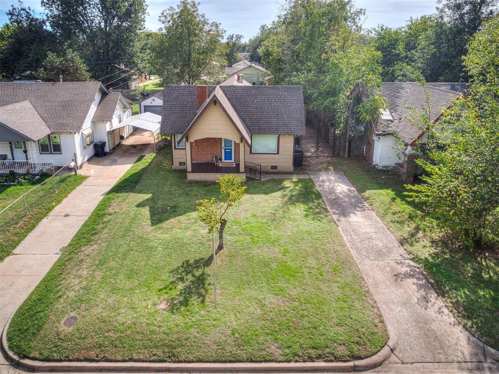 Welcome to Historic Miller, in the heart of OKC and just minutes from the Plaza District! This well-maintained, move-in ready bungalow offers all the charm this beloved community is known for, plus the updates that matter: energy-efficient double-pane windows and an updated electrical.A covered front porch with a brick and cafe lighting invites you to slow down and stay a while. Inside, refinished original hardwood floors run through a bright, spacious living room anchored by a stunning white-painted brick fireplace with a classic overmantel and built-in shelving. Vintage details shine throughout, from the original paneled door with its brass mail slot to a hallway built-in bookcase backed by exposed original brick.The kitchen is a true highlight: generously sized, with an abundance of storage. Shaker-style cabinetry wraps the room, joined by built-in pantry cabinets and granite countertops with a glass mosaic backsplash. Stainless appliances include a gas range with vent hood, and there’s room for laundry right in the kitchen. The bathroom pairs historic character with modern updates: a vessel sink on a granite vanity, a vintage built-in medicine cabinet, and a fully tiled tub surround with bench seat. A French door with etched glass opens to a flex space with  ideal for an office, or workout room. The bedrooms offer built in larger closet space for your storage needs. Out back, the deep, tree-shaded yard offers room to garden, play, or entertain, with a patio,fencing, an iron-gated drive, and a storage shed that matches the home for more storage needs.Life in Miller means tree-lined streets, early 20th-century architecture, and an active voluntary association for home tours and parties, with the Plaza District’s local shops, restaurants, and Lyric Theatre just down the road and quick access to Midtown and downtown. Call today for your private showing!!!