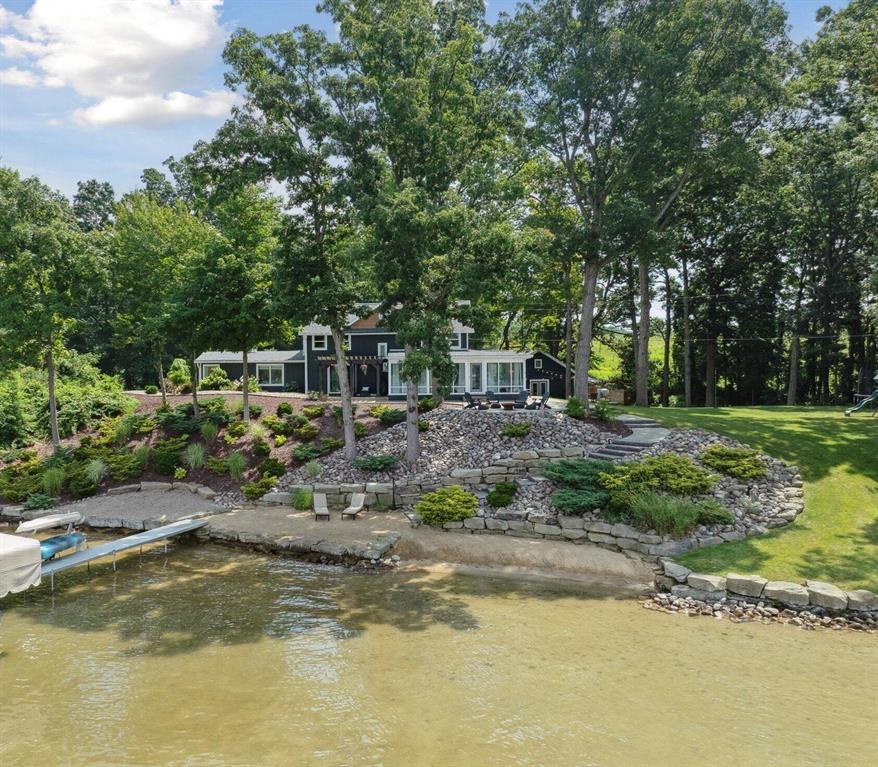 Don't miss your chance to own a rare gem on one of Michigan's most sought-after all-sports lakes!Welcome to 240 Aquamarine Lane in South Central Michigan--a beautifully maintained and luxurious 2-story lakefront home offering 233 feet of shallow, sandy-bottom frontage on Farwell Lake, a spring-fed lake known for its clear, Caribbean-colored water. Connected to a scenic chain of lakes including Pine Hill and Fox, it's ideal for boating, relaxing, and fishing.Inside, the thoughtfully designed main level features multiple living spaces with lake views throughout--a cozy living room with a fireplace, an additional family room for flexible use, and a chef-style kitchen with granite countertops, stainless steel appliances, and a walk-in pantry.A sunroom with built-in bar opens to two outdoor patiosone with a natural gas fire pit and another with a pergola-covered lounge space, perfect for morning coffee or lakeside dining.

The recently remodeled primary suite is a true retreat with a custom walk-in shower, soaking tub with lake views, high-end finishes, and a sizable walk-in closet with custom cabinetry. A guest half bath, laundry room, and generous living space complete the main level.

Upstairs offers two spacious bedrooms, a full bathroom, and two walk-in closetsideal for family, guests, or home office space.

The oversized detached garage and workshop offers ample upper-level storage, room for cars, boats, or lake toys, and a finished 225 sq ft workout room that opens to an additional private patio. The building also includes a 30-amp RV hookup and a generator connection for added convenience.

The property includes a long private driveway, professionally landscaped grounds with in-ground sprinklers, and a fully fenced raised Vego garden perfect for vegetables, herbs, or flowers.

This home delivers year-round enjoyment: boating and relaxing in summer, ice fishing, snowshoeing, and skating in winter, and scenic views of the nearby Christmas tree farm. You'll also enjoy stunning sunsets over the lake and front-ro