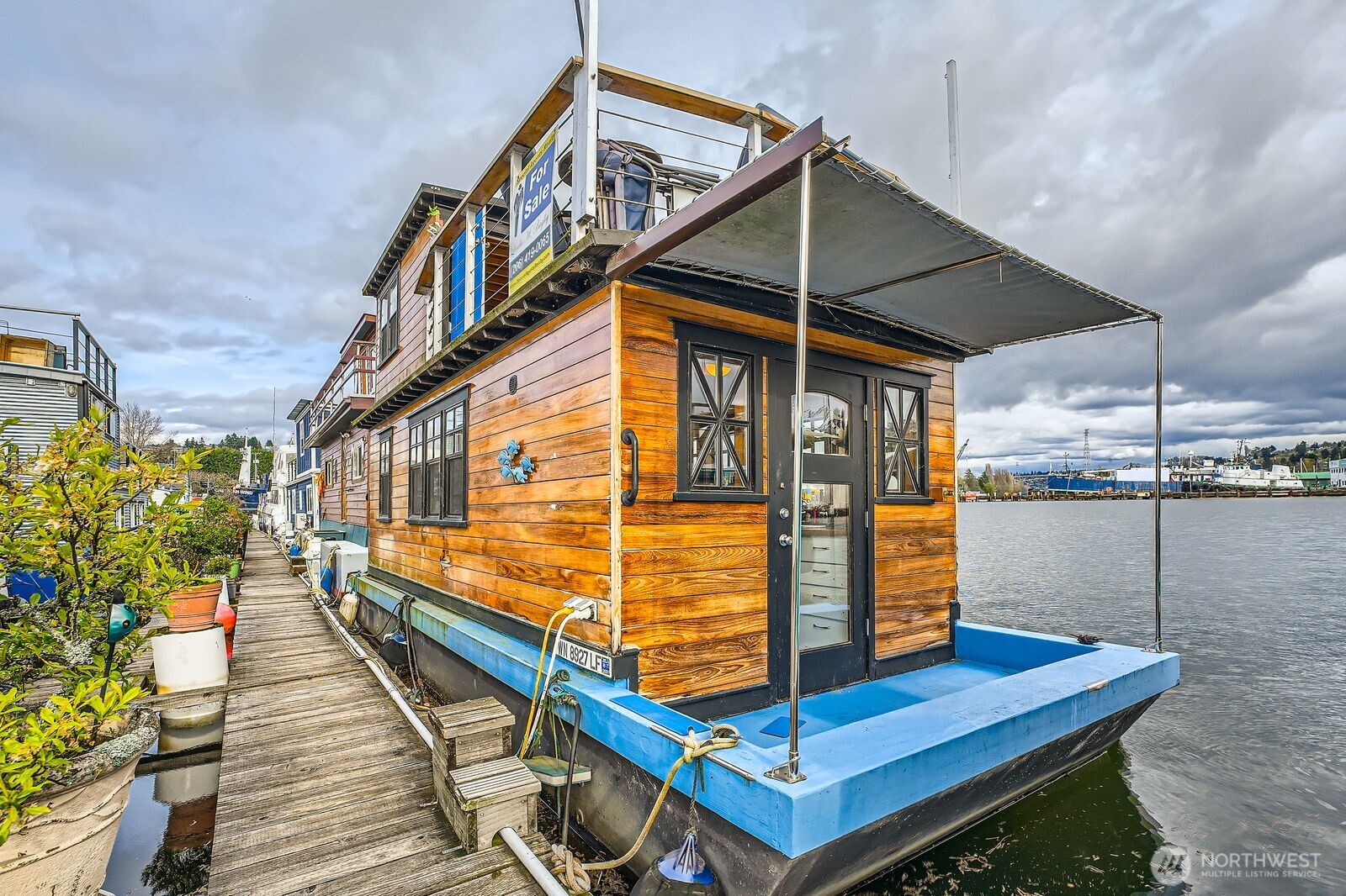 SELLER OFFERING $5,000 TOWARD BUYER CLOSING COSTS!  Welcome aboard this charming Seattle Houseboat with unobstructed VIEWS towards Lake Union and the Fremont Bridge.  Enjoy the peaceful water life while watching boaters, rowers, & larger ships gliding around the lake.  Watch breathtaking sunsets/sunrises from the rooftop deck, complete with mini fridge in the storage cabinet.  Houseboat includes warm hardwood floors, window-wrapped walls, fully furnished kitchen with propane stove, washer/dryer combo, and comfortable living area with big screen TV & Bose speaker.  All furnishings included!  Hull fiberglass over wood, last hauled out in 2023.  Slip rent $878/month, includes water, garbage, & parking. No pets or rentals!
