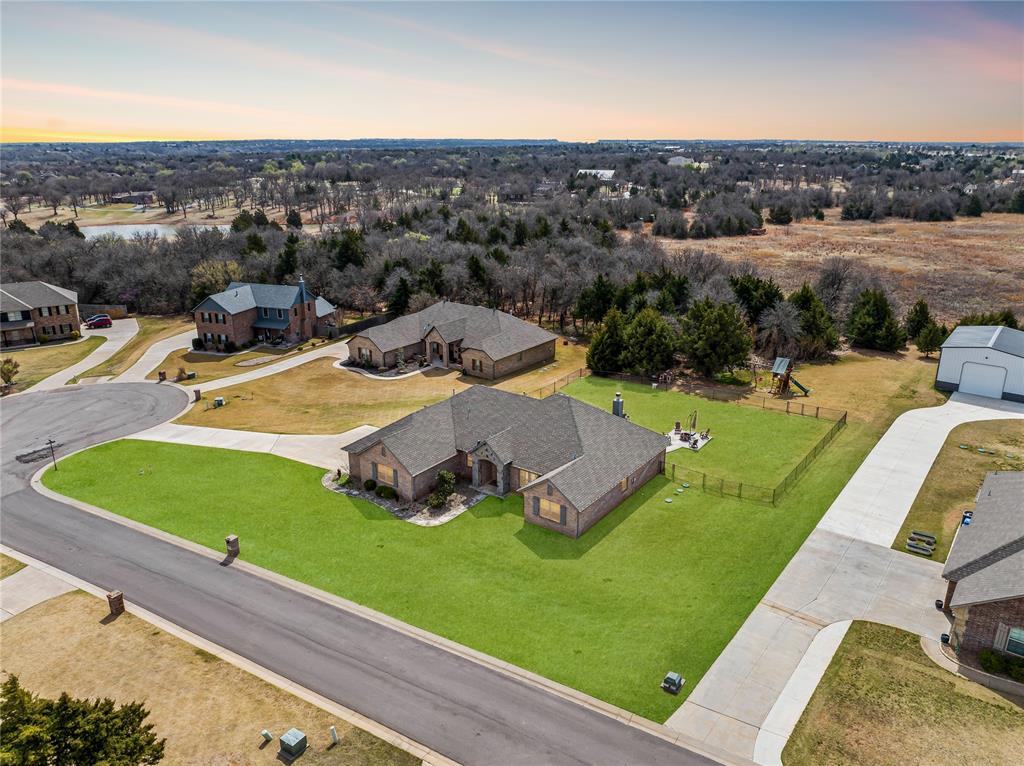 Welcome to the North Pointe acreage community at 1487 Bridge Street, where peaceful surroundings meet comfortable living and modern convenience. Situated on a spacious homesite, this beautifully designed residence offers the perfect blend of privacy, functionality, and inviting living spaces in the highly sought-after Edmond School District. The welcoming living room opens seamlessly to the kitchen and dining area, creating an ideal layout for everyday living and entertaining. A stylish corner fireplace adds warmth and character, serving as a focal point for gatherings with family and friends. Large windows bring in natural light and enhance the open feel of the home. The kitchen is thoughtfully designed with both beauty and functionality in mind. A center island with a sink overlooks the living room, allowing the cook to stay connected to guests and family while preparing meals. The space also features a pantry, generous counter space, and ample cabinetry to accommodate all your cooking and storage needs. The private primary suite provides a relaxing retreat at the end of the day, complete with an ensuite bathroom designed for comfort and convenience. Three additional bedrooms are generously sized, offering flexibility for family members, guests, or additional workspace. Just off the entry, a dedicated study with a glass door creates the perfect space for a home office, reading room, or quiet workspace. Step outside to enjoy the covered backyard patio, an ideal place for relaxing evenings, outdoor dining, or simply taking in the peaceful surroundings. With acreage living, you'll have plenty of room for outdoor activities. The property features the convenience of a private well and septic system while still being located within easy reach of Edmond amenities. Schedule your private showing today and experience the lifestyle you’ve been dreaming of. Welcome Home.