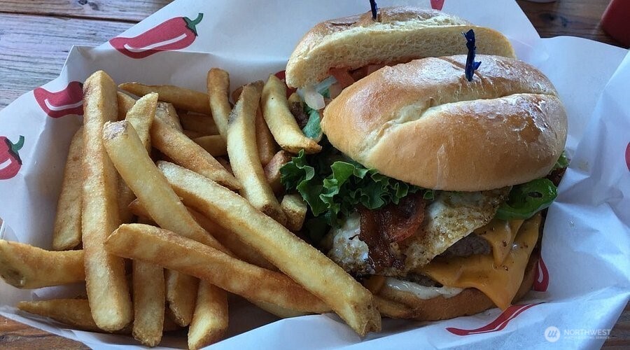 Own a thriving, turn-key burger restaurant at the gateway to Mt. Rainier National Park, White Pass Ski in Packwood, WA!  For the owner ready to trade a paycheck for equity, the business is a rare live-work package: a proven, 15-year restaurant with an attached apartment, on Highway 12's main stream of hikers, skiers, and short-term-rental traffic heading to prime recreation areas. This isn't a startup — it's an established local favorite with 15 years of 4-star-plus reviews, ready for an operator who wants to run it as their own from day one. The sale includes the 1,833 SF building, a 588 SF attached apartment for on-site living, and the full FF&E and inventory needed to operate day one — walk-in and reach-in refrigeration, three-compartment dish sink, prep tables, deep fryer, four-burner gas grill and hood, POS system, indoor dining, and covered outdoor seating, parking for 11+ vehicles. No build-out, no equipment hunt — just an owner-operator ready to work.  Numbers That Reward Hands-On Ownership! Gross sales have run $375,000 +/- annually since 2022, with a reported $162,000 net operating income and a 16% cap rate at the current asking price. Sales are seasonal, with June–September driving the bulk of revenue — leaving real upside for an on-site owner to extend hours, add offerings, or capture more of Packwood's growing tourism and short-term-rental demand outside peak months. The real estate is Zoned STMU, commercial, residential, STR okay.