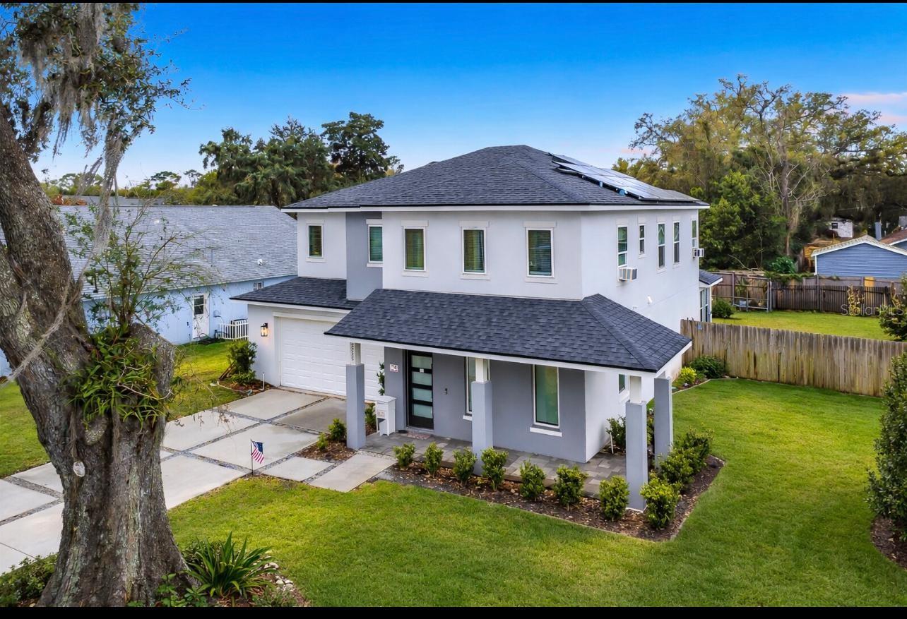 Built in 2022, this exceptional contemporary home is located in the highly desirable Downtown SODO district! Offering 4 bedrooms, 3 bathrooms, and 2,724 sq ft of thoughtfully designed living space, this newer construction blends modern style, energy efficiency, and everyday comfort in a prime central Orlando location.Inside, the open and airy floor plan is filled with natural light and enhanced by 10-foot ceilings on both floors, recessed lighting, and ceiling fans throughout. The gourmet kitchen is perfect for entertaining and daily living, featuring all-wood soft-close cabinetry, quartz countertops, stainless steel appliances, smooth glass cooktop, built-in oven and microwave, a spacious breakfast bar, and a large walk-in pantry.Upstairs, a spacious loft offers flexible use as a home office, fitness room, media space, or play area. Enjoy outdoor living on the covered paver lanai overlooking a large private fenced backyard with room to add a future pool.This home also features Tesla solar panels that will be fully paid off by the seller at closing, providing immediate energy savings, along with a built-in Tesla EV charger for electric vehicle convenience.Situated on two combined lots measuring approximately 80’ x 140’, this property offers additional outdoor space rarely found in the area.Experience modern, energy-efficient Florida living in one of Orlando’s most sought-after locations—schedule your private showing today.