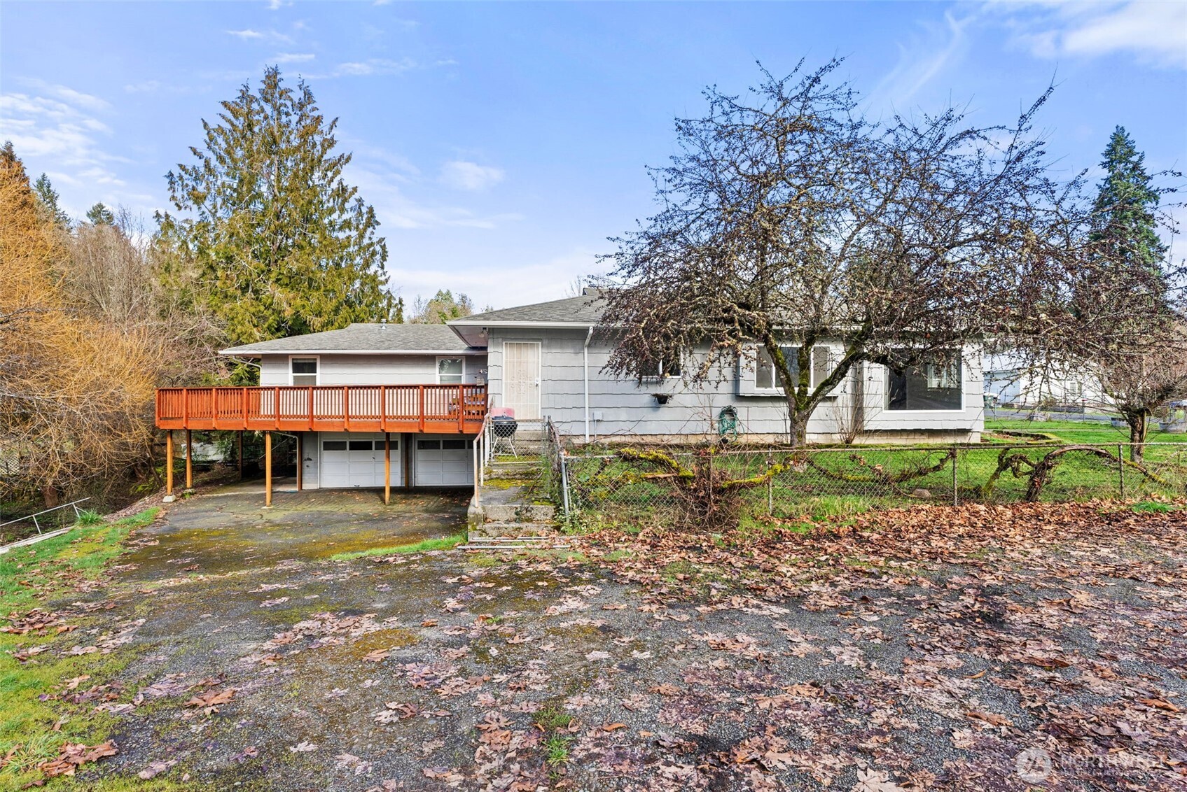 Welcome to your own private waterfront retreat featuring 89 ft. of Olequa Creek frontage, where you can fish, swim, & enjoy direct private creek access right from your backyard. This exceptional property blends natural beauty w/versatile living in a spacious 3,362 sq ft home designed for comfort & flexibility. This unique home showcases a studio-style primary suite with a private kitchen & bathroom, thoughtfully positioned apart from the main living areas—ideal for multi-generational living, extended guests, or independent living. A newer deck provides the perfect space for entertaining or relaxing while overlooking the serene creek. Recent updates ensure peace of mind, including a new roof, new double pane storm windows & fresh interior/exterior paint within the last 5 years. The property also features an attached 2 car garage plus a carport, offering ample covered parking & storage. The expansive 1,600 sq ft lower level offers exceptional versatility—ideal for a custom workshop, additional living quarters, fitness studio, media lounge, or recreation room. Seamlessly connected to the attached two-car garage, this space provides both convenience & endless potential for lifestyle expansion. Designed w/comfort in mind, the home is equipped w/2 natural gas water heaters, ensuring an abundant & consistent hot water supply. A heat pump system delivers both heating & cooling, maintaining year-round comfort w/climate control.  Front yard is fenced & there are fruit trees. Near I-5.