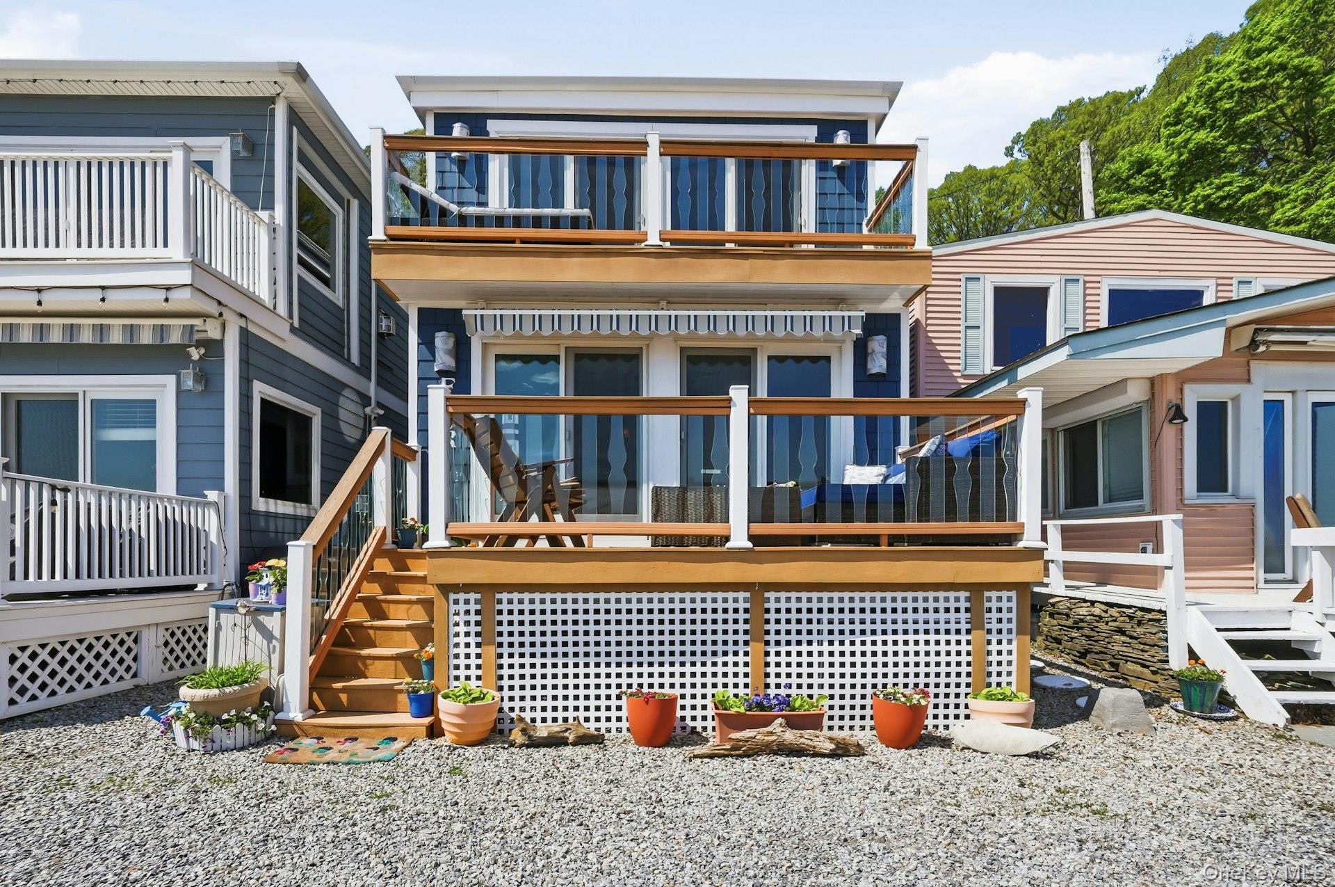 Spectacular Beachfront Paradise! Enjoy year round waterfront living in this 2 bedroom/2 bath home with sweeping harbor views from every principal room and multiple decks. Rebuilt from the ground up in 2008, this stunner has floor to ceiling glass sliders, storm resistant doors and windows, new roof (2021), natural gas, and is in perfect condition. Reserved parking steps away from front door and right across from the private association sandy beach. Private dock, kayak storage, mooring rights, gorgeous sunrises…You'll never want to leave home.