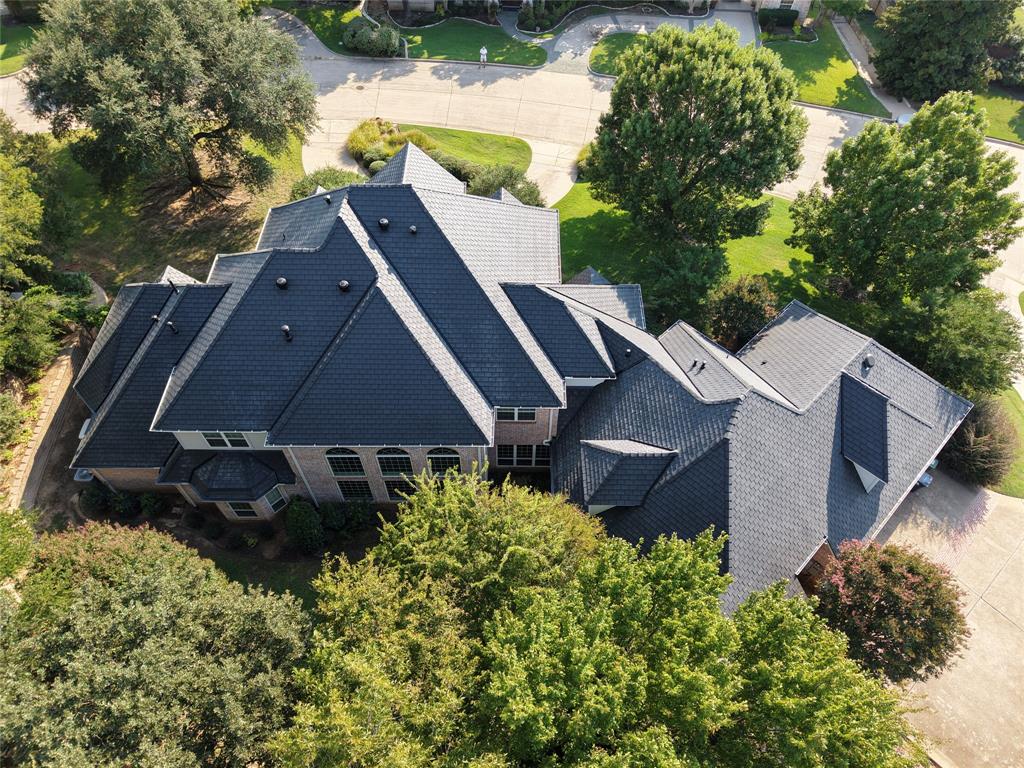 Gated,.92acre,move-in ready:featuring:2025 DaVinci slate roof, Sub-ZeroWolf appliances, renovated baths, a whole-home generator, and meticulous professional maintenance throughout.This residence offers a rare combination of privacy, scale, and long-term value. Recent upgrades include new gutters and garage doors, designer interior and exterior paint, upgraded remote-controlled exterior lighting, and energy-efficient LED recessed lighting throughout. New carpet enhances all upstairs living areas and downstairs bedrooms.The chef’s kitchen is appointed with a Kohler sink, Sub-ZeroWolf refrigerator with custom cherry panels, and an ASKO dishwasher:suited for both everyday living and entertaining. Renovated baths feature premium soft-close cabinetry, granite countertops, updated hardware, a comfort-height commode in the primary suite, and framed vanity mirrors convey.Set on nearly an acre of manicured grounds, the property features a circular drive, secondary driveway, oversized three-car garage. A dramatic entry with 23-foot ceilings and marble flooring opens to a formal dining room framed by stately columns, flowing into the expansive family room and kitchen. A butler’s pantry enhances storage and entertaining functionality.A thoughtful 2015 expansion adds a spacious family room, office, exercise room, additional bath, and generous storage—providing substantial living area not reflected in public records.Mechanical systems reflect careful ownership: fiveHVAC units(three Carrier systems installed in 2021;two Lennox systems from 2015), three water heaters (2024), full spray-foam insulation, and a Generac whole-home generator with a 10-year warranty. Additional features include an air-conditioned, carpeted bonus room with plumbing in place—ideal for recreation, storage, or future conversion.Professionally maintained inside and out by the same trusted firms involved in the home’s original construction, this residence delivers quality, confidence, and true turnkey living.