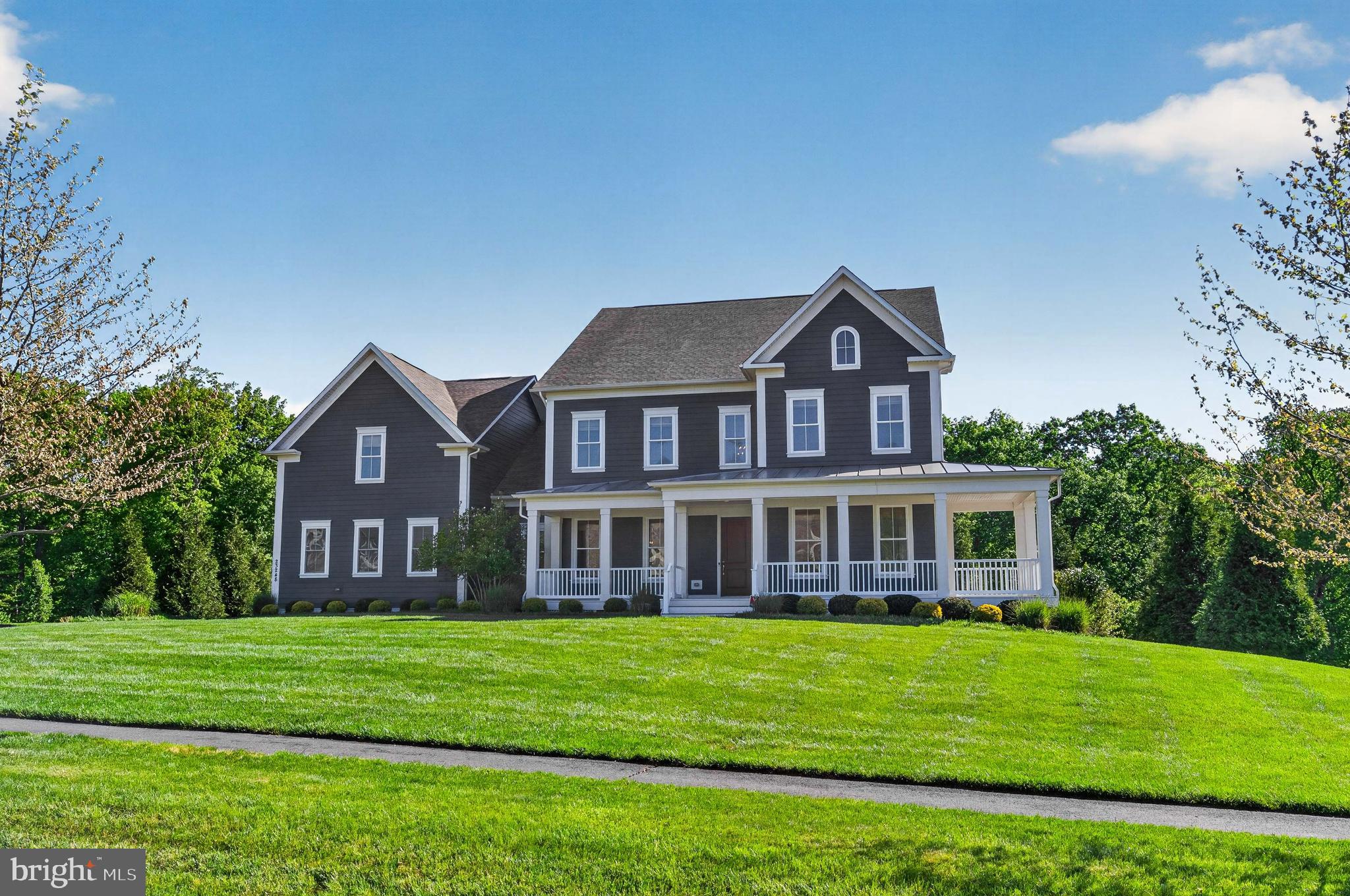 Welcome home! This Winchester - Camberley Homes Milburn model is a masterpiece! Three luxurious levels, boasting a blend of luxury and comfort. Featuring exceptional builder upgrades throughout. All this topped off with a premium lot backing to the conservatory woods!  Large wrap around porch, the home faces west, with a surreal setting for summer eves to come!   (Please see the 3D active tour link for a rich, inviting experience to this marvelous home.) From the front door enter to a two-story foyer and an array of classic moldings and accents, gorgeous pre-finished, wide plank hardwood floors, 10ft ceilings and neutral colors throughout. To the left is the formal dining room with chair rail, shadow box, crown moldings, designer fixtures. To the right, we have a convenient professional office or formal living space. Continuing on the main level is a captivating, large open floor plan great room and gourmet kitchen flooded with natural light from 12 windows and a walk out balcony door. The kitchen is exceptional with a 13ft center island and spectacular slab of Delicatus granite, stainless-steel, high-grade appliances, hood system & gas cooktop.  A newer french door refrigerator, and deep farmhouse sink. The great room boasts a huge footprint perfect for entertaining at 21’ x 23’ with coffered ceiling and gas fireplace for incredible ambiance. Adjacent to the Kitchn is a fabulous morning room addition, with a walk-out to rear, covered deck and overlook. An amazing feature for taking in the serene, wooded setting!  Enter from the garage to the large mudroom with built in cubbies and bench & back second staircase . The upper level hosts 9ft ceilings, generous 4 bedrooms, each with an en-suite bathroom and walk in closets. There is a convenient upstairs laundry room and multiple additional storage closets with built in shelving. The owner’s suite is to die for! With tray ceiling and adjacent large sitting area or additional office space, and  a fantastic personal walk out balcony overlooking the rear yard. Enjoy the morning coffee on this spectacular home feature! A large his & hers closets flank the incredible luxury bathroom with his & hers vanities, large walk-in shower and soaking tub, to complete this gorgeous owner’s suite. The basement level is a classic walk out with all the necessities! A full bedroom, full bathroom, and large entertainment space & muti-purpose room,  9ft ceilings and loads of natural light throughout. The lower level is also equipped with plumbing for full wet bar and pre-wired for surround sound for any entertainment media. Additionally there’s  abundant storage w/ utility systems, upgraded HVAC, whole house humidifier & whole house custom water filtration. walkout the basement to a massive flagstone patio flanked by professional landscaping of hydrangeas, ferns, hostas, tall grasses, cherry blossom trees, maple trees and crape myrtle trees  front and back irrigation and landscape lighting to enjoy this backyard oasis.  There is a covered outdoor kitchen space for grilling. So much to promote with this meticulously cared for home! The Grant Village of Willowsford, an award winning agri-hood community offering a luxury lifestyle and conveniences. The Willowsford Community boasts a working farm and farm stand with seasonal offerings, multiple pools, small lake for kayaking or canoeing, 13 mi. of walking trails, family campgrounds, dog park, playgrounds, community gym, available event venues, courts and social clubs all add to the vibrant modern living recipe. Truly a one-stop “has it all” community. 35 miles to Washington DC with fantastic commuter convenience to major thoroughfares, traffic free toll roads, metro stops and easy access to shopping, services,and social destinations within minutes to beautiful Virginia Wine Country. To cap it all off, the school system is in the highest ranks for the country!