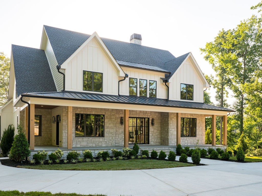 Perched on 9.76 private acres, this stunning new construction by Haven Developments delivers 360° of hilltop seclusion and luxury living in Williamson County, just 10 minutes south of Leipers Fork Village. A gated entrance and wooded chip and tar driveway lead to the hilltop home, offering 4,265 sq ft of thoughtfully designed space with 4 bedrooms, 4.5 baths, a home office, bonus room, and full pool bath — built for modern comfort and entertaining. Inside, a great room filled with natural light showcases floor-to-ceiling windows and sliding patio doors for seamless indoor/outdoor living. Custom white oak cabinetry, Taj Mahal countertops and Thermador appliances, complemented by white oak beams and high-end finishes at every turn. A full walk-through scullery with sink, ice maker, and wine cooler makes entertaining effortless. The home office is equipped with built ins, natural light, and a patio door to the expansive porch. The spacious primary suite and oversized custom en suite and primary closet offer a private retreat. Upstairs, a landing area and bonus room add flexible living space for the additional 3 bedrooms upstairs. Out back, the home opens to its own private resort: a 16x32 gunite saltwater pool with tanning ledge and spillover 8x8 spa, framed by marble pool deck pavers allowing for amble amounts of entertainment and lounging. The outdoor kitchen is built out with a BBQ grill, griddle, and beverage fridge, making it ideal for entertaining, complete with a pool deck-accessible full bath and outdoor pool speakers. Enjoy breathtaking sunset views from the back patio and pool deck, and sunrise from the expansive front porch.